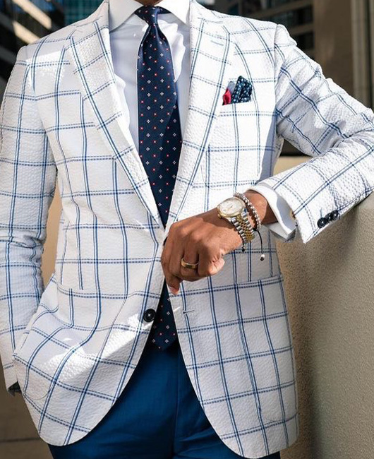 Blazer élégant à carreaux, revers cranté, poches et deux boutons