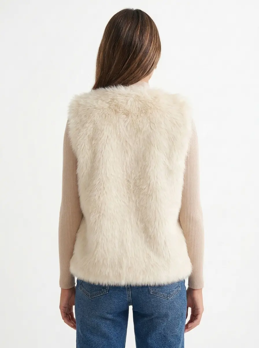 Back view of a women's cream faux fur vest
