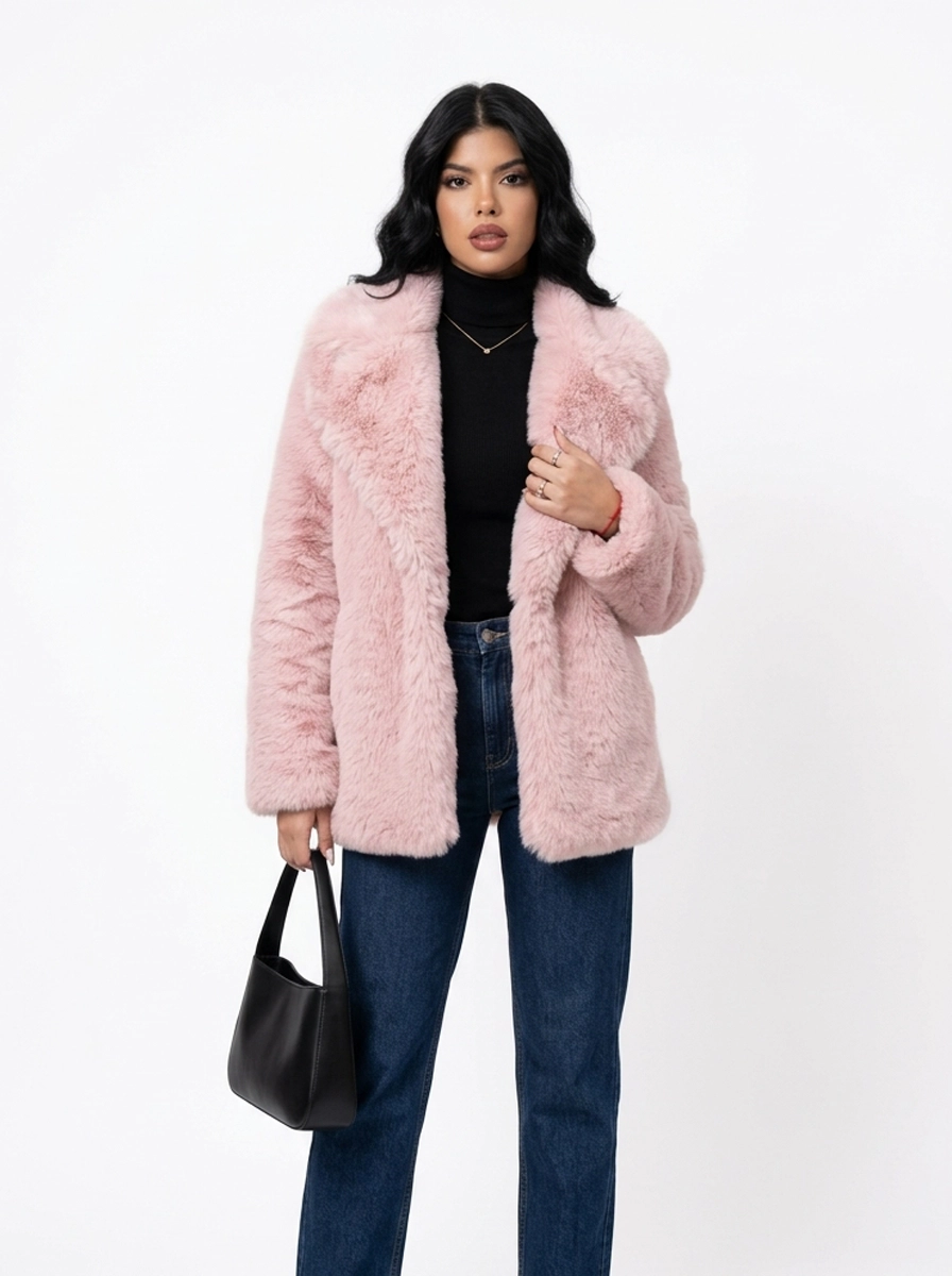 Woman modeling a pink faux fur coat with blue jeans