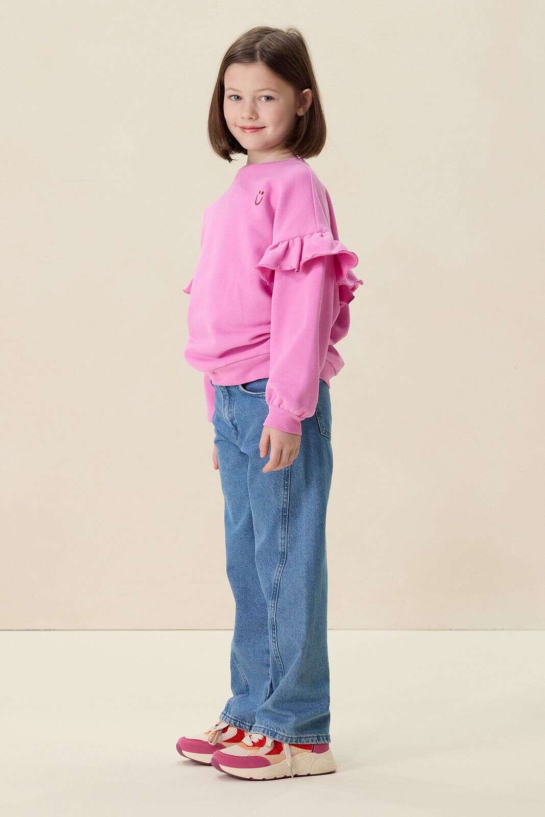 Roze oversized sweater met ruffles