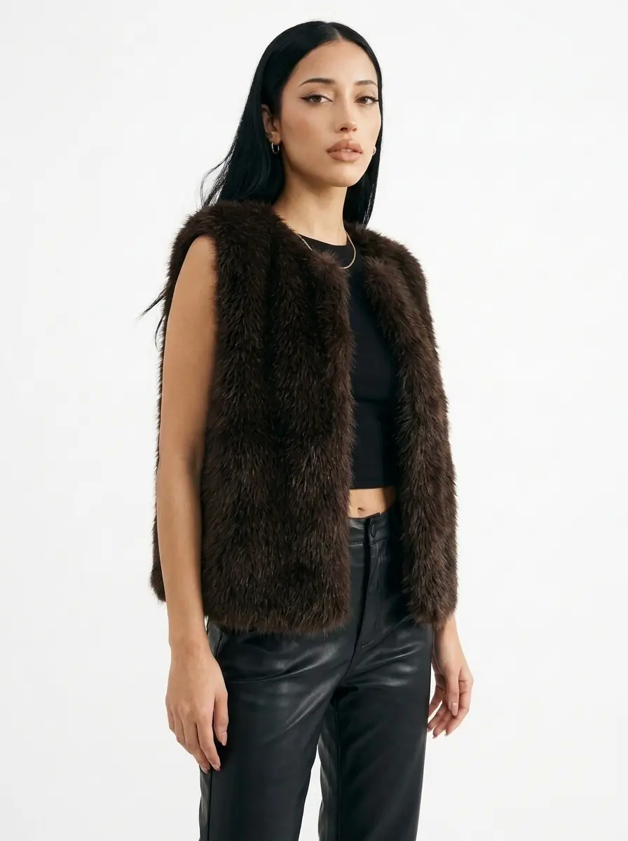 Front view of a woman wearing a dark brown faux fur vest
