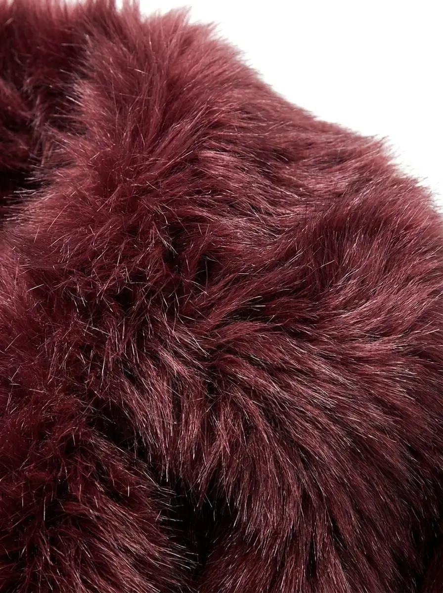 Close-up of soft maroon faux fur jacket texture