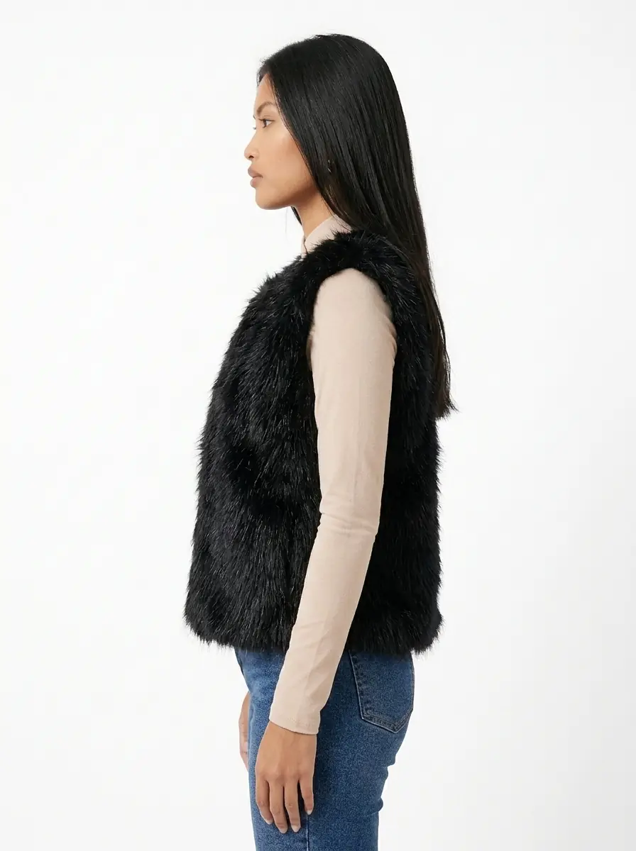 Side view of a woman wearing a black faux fur vest