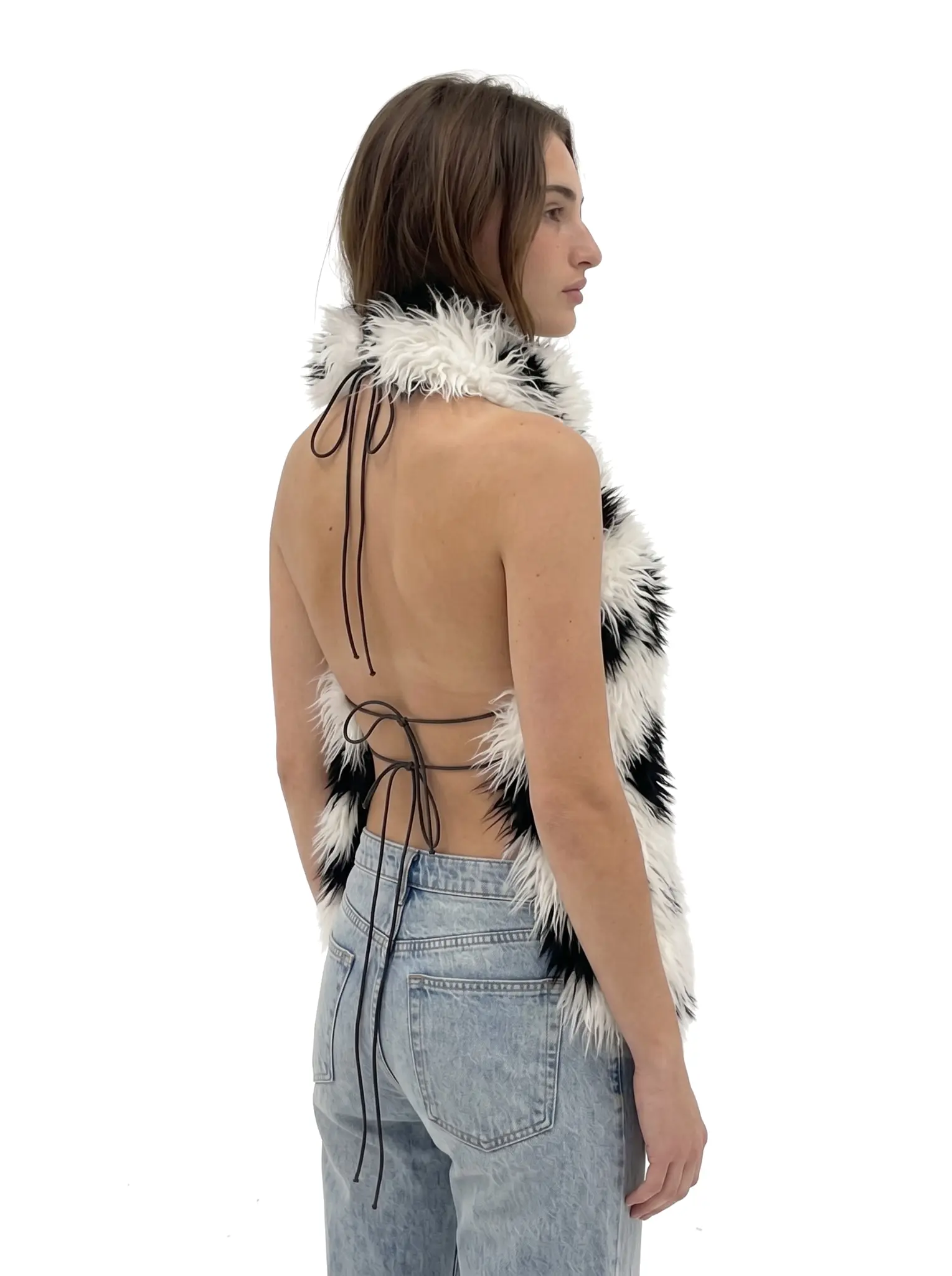 Woman wearing a spotted shaggy faux fur halter vest, front view
