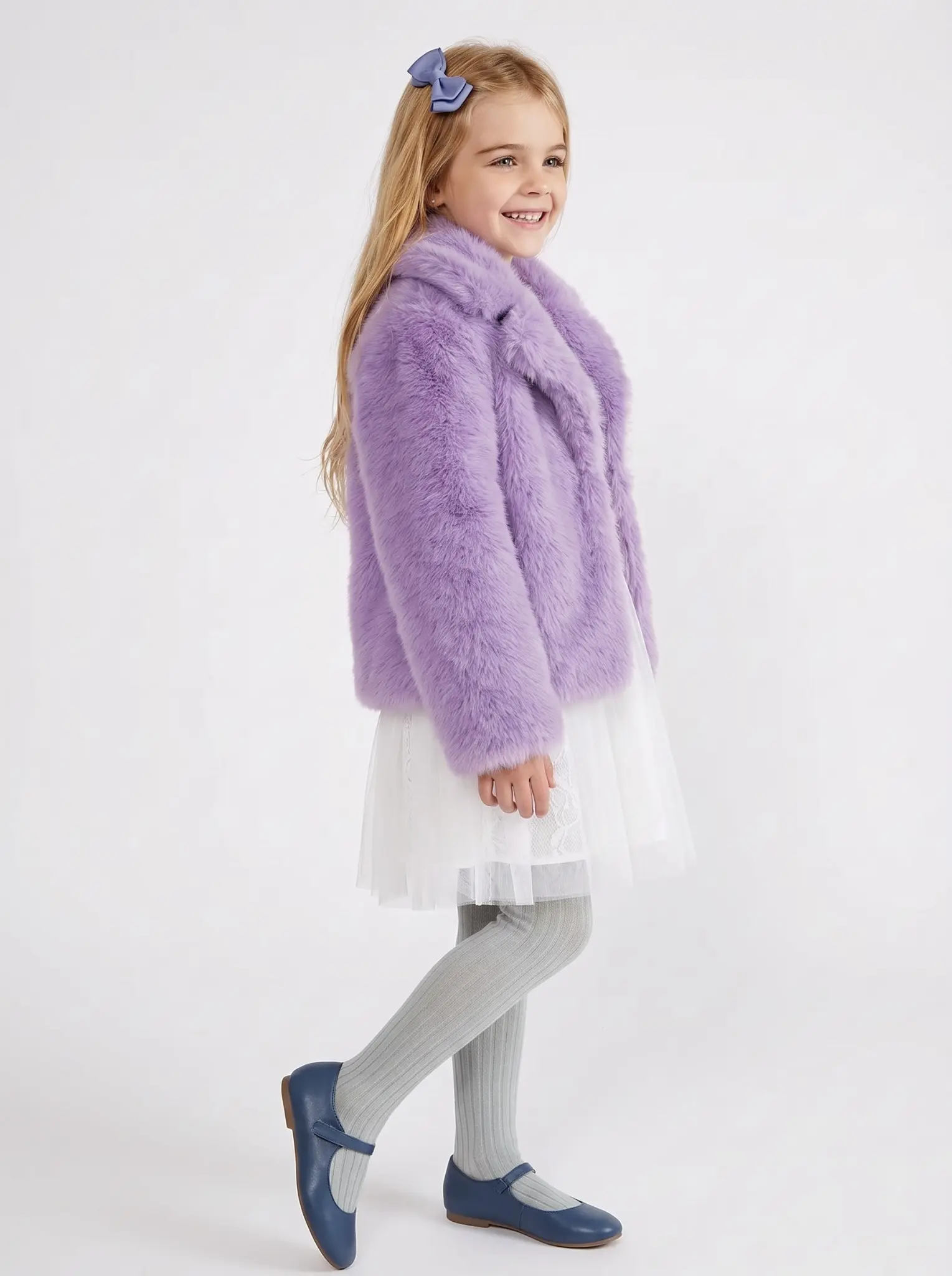 Smiling girl wearing a lavender faux fur jacket with a bow hair clip