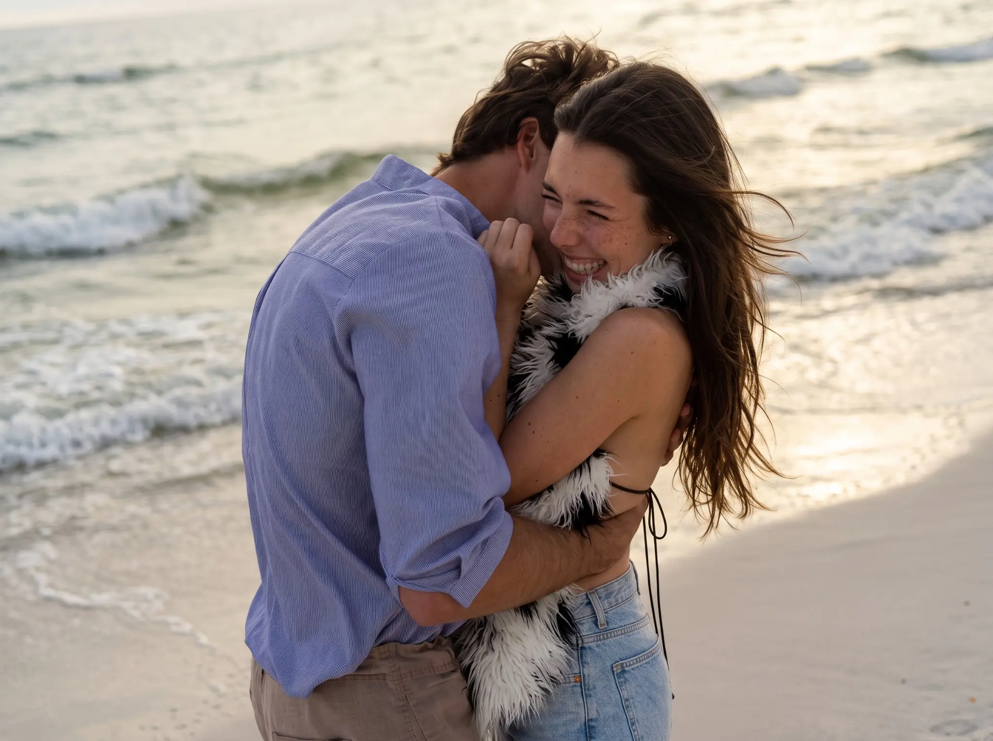 Couple on a beach date with a woman wearing a spotted faux fur halter vest