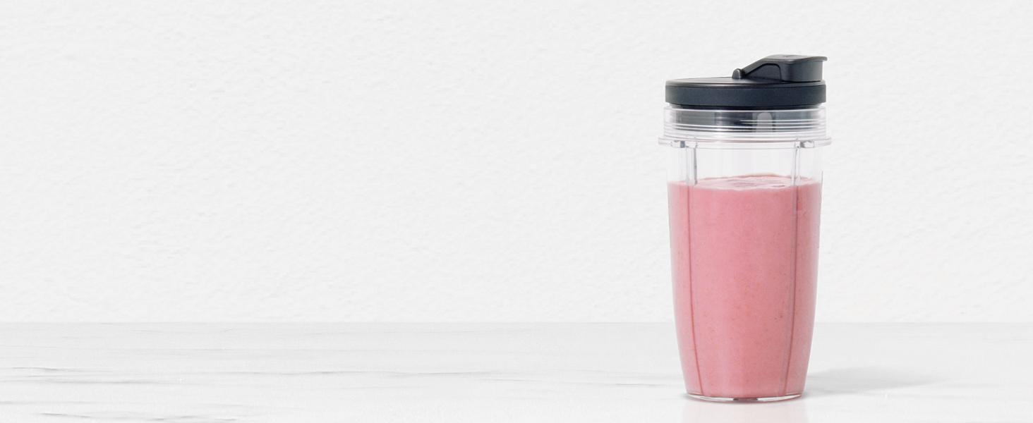 pink smoothie in a single serve cup with spout lid