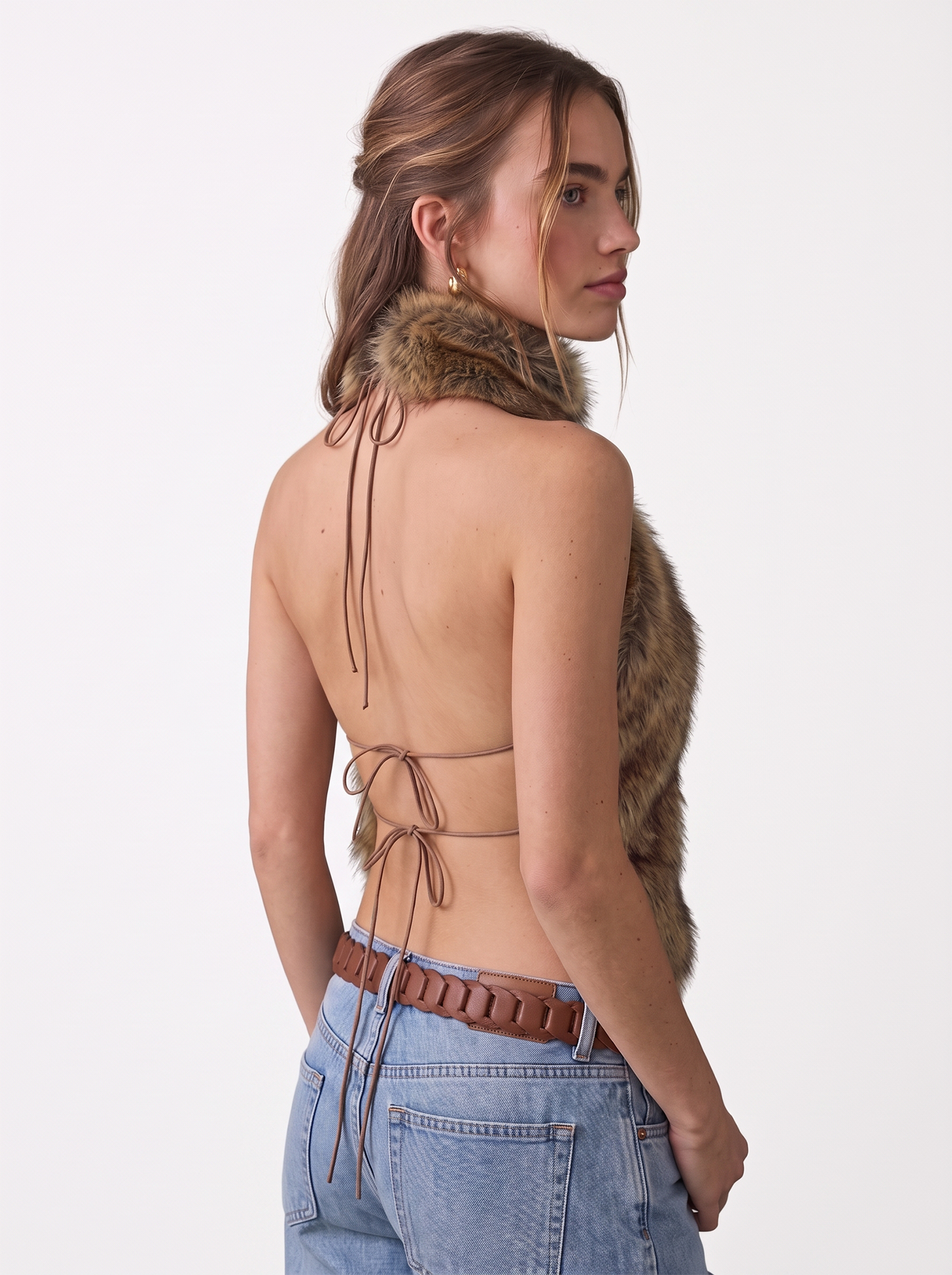 Profile view of a woman wearing a brown faux fur halter vest