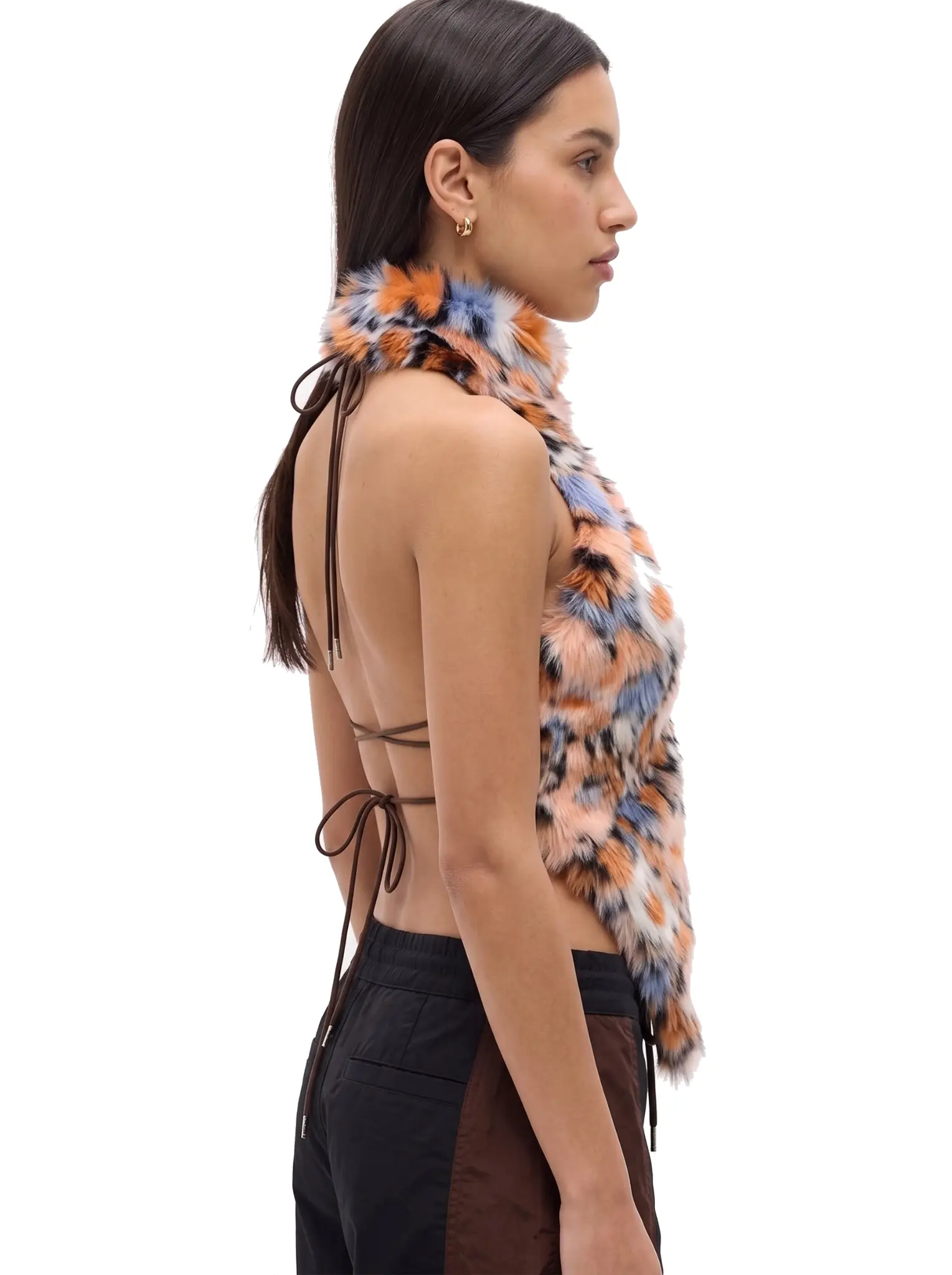 Right-side profile of a woman wearing an orange and blue spotted faux fur halter vest