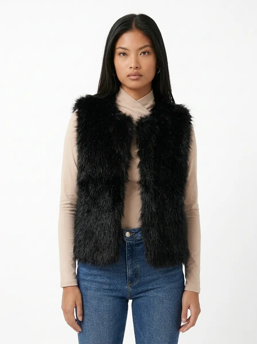 Front view of a woman modeling a black faux fur vest