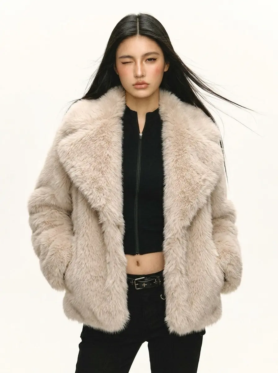 Woman modeling a beige faux fur jacket with black pants