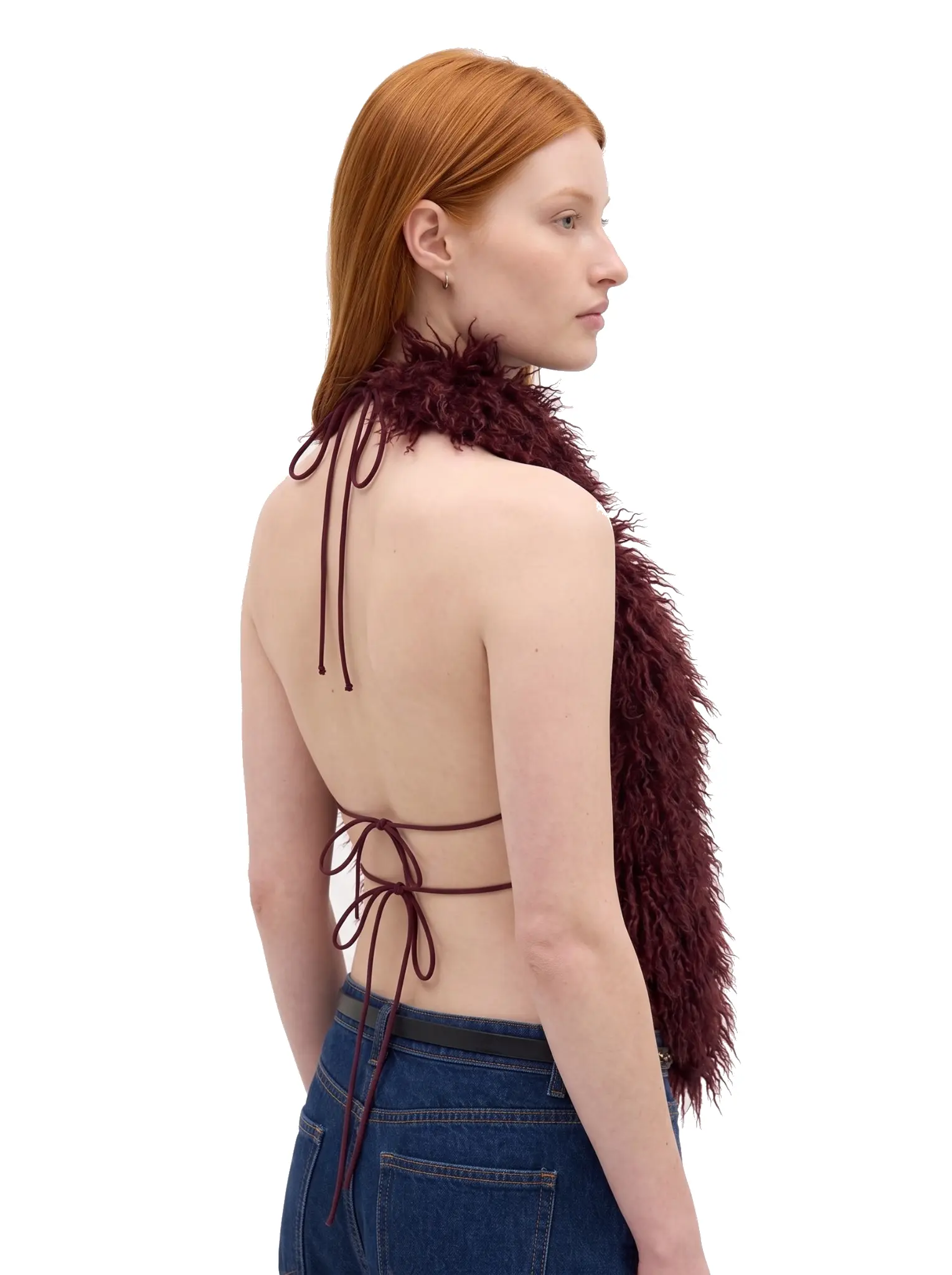 Right-side profile of a woman wearing a maroon shaggy faux fur halter vest
