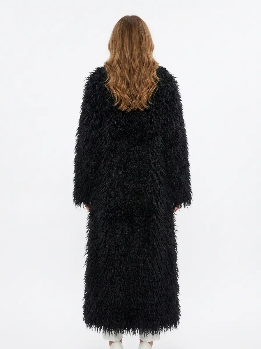Back view of a black long faux fur coat on model