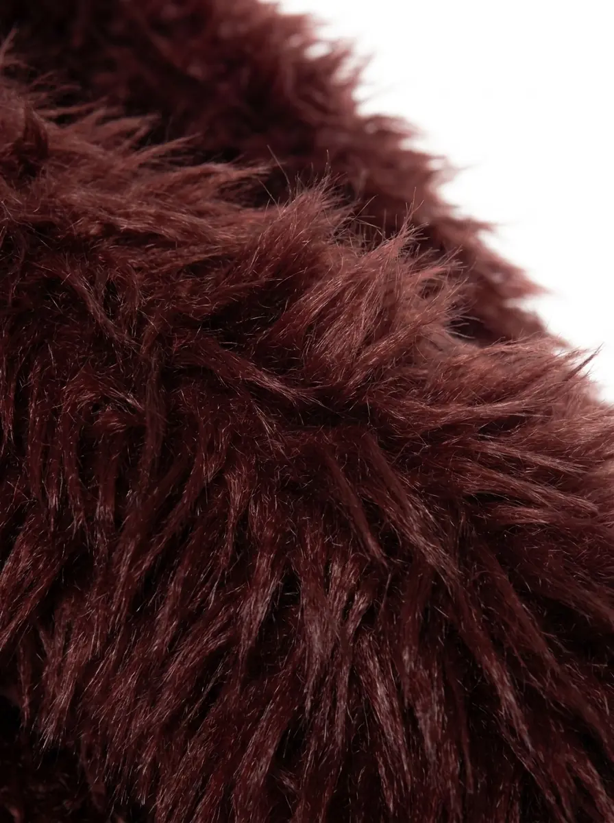 Close-up of soft maroon faux fur jacket texture