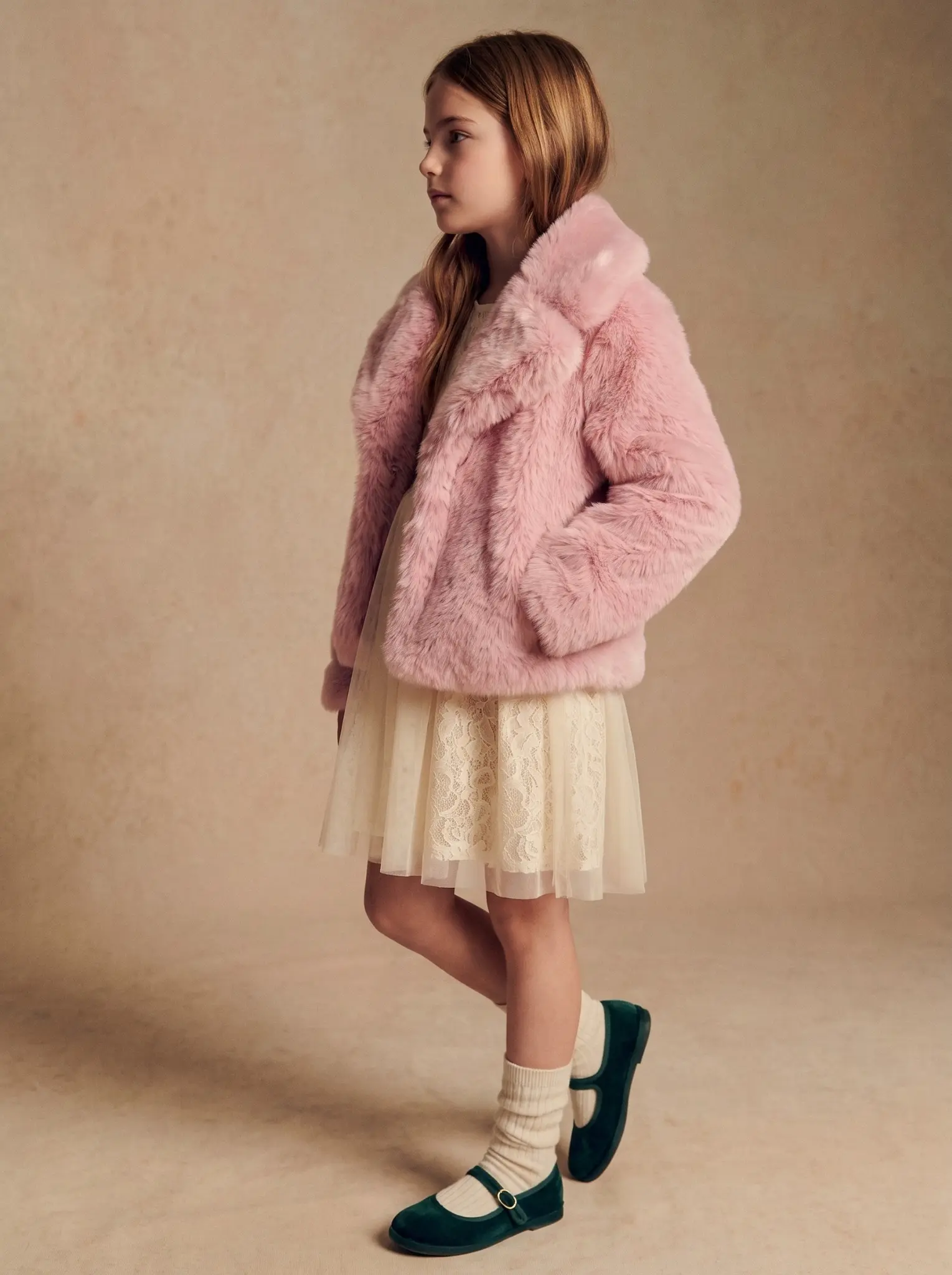 pink-faux-fur-jacket-girl-three-quarter-view.webp	Girl posing in a pink faux fur jacket with an oversized collar