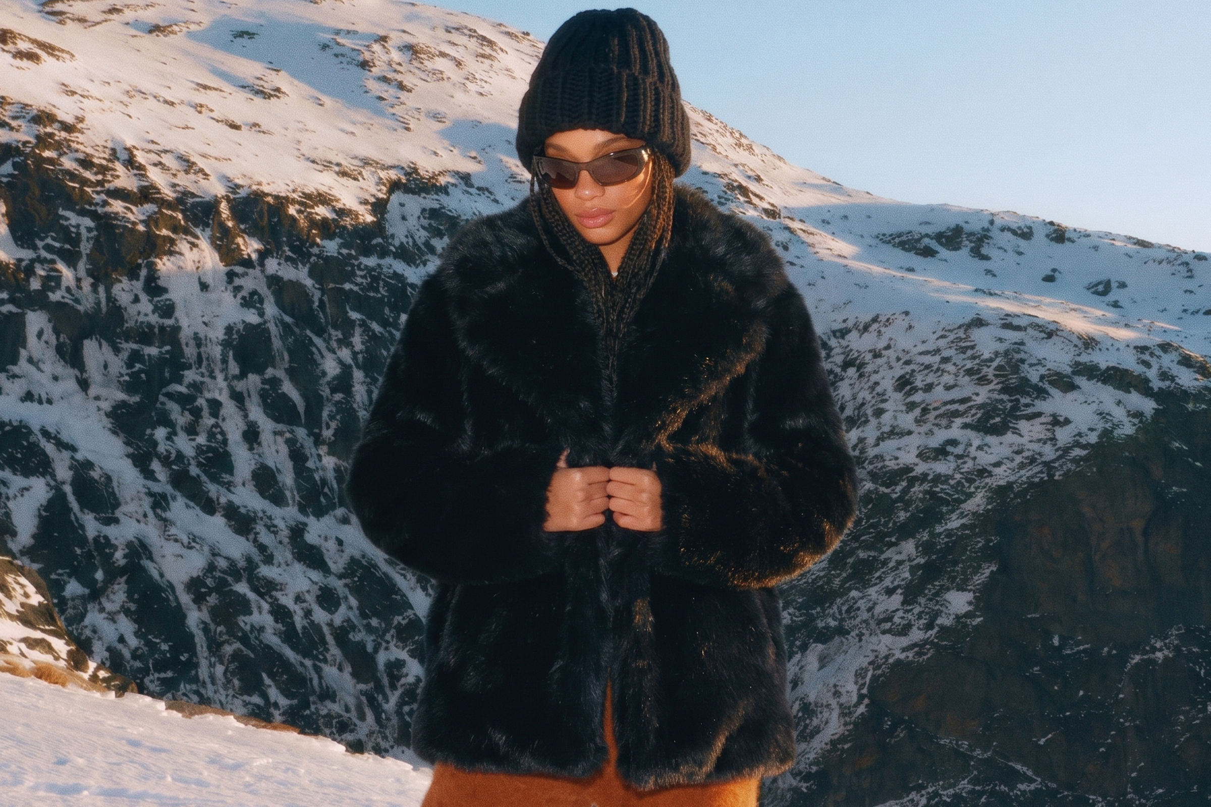 Stanetco black faux fur coat styled in the snow-covered mountains