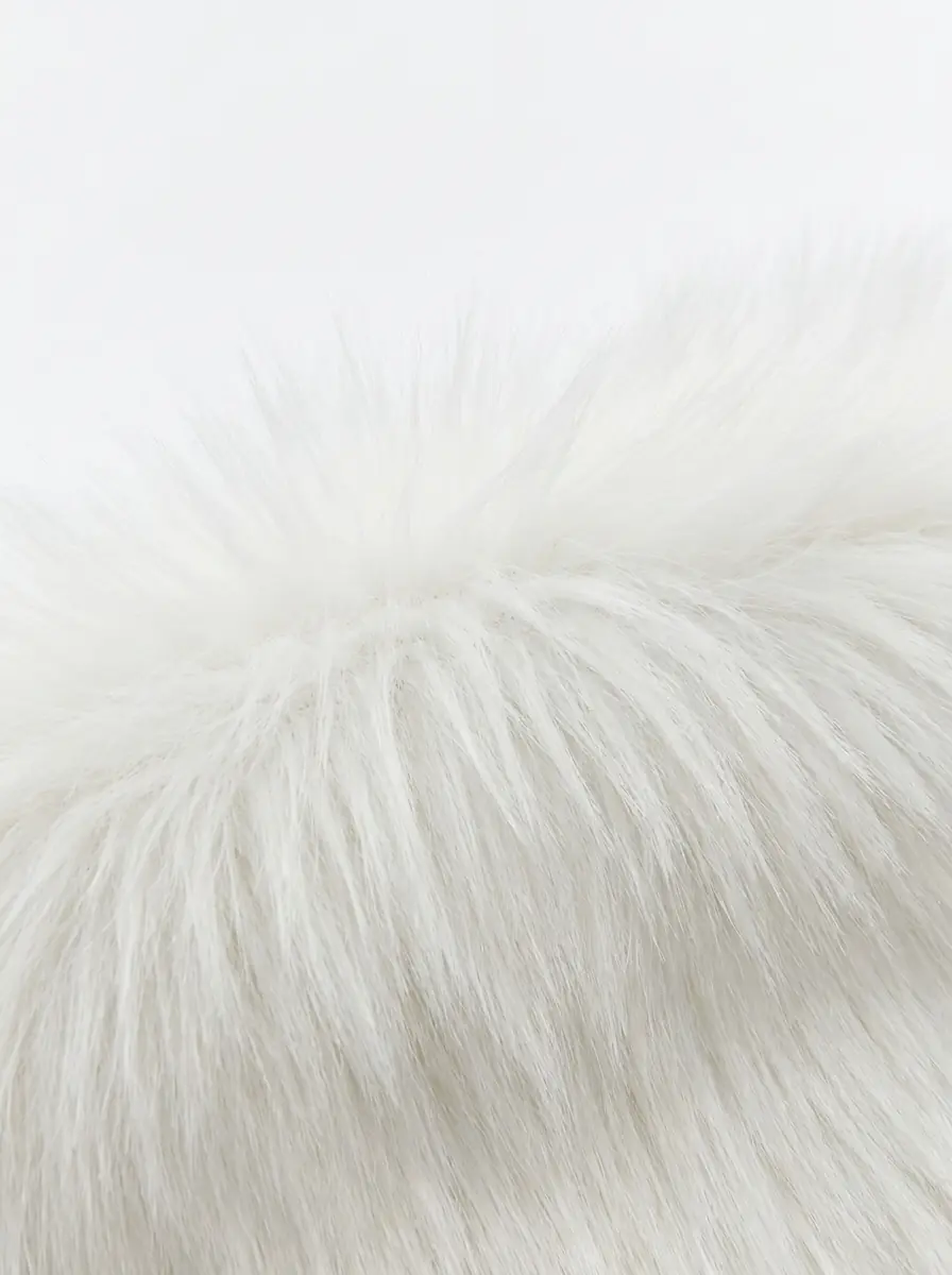 Close-up of soft white faux fur vest texture
