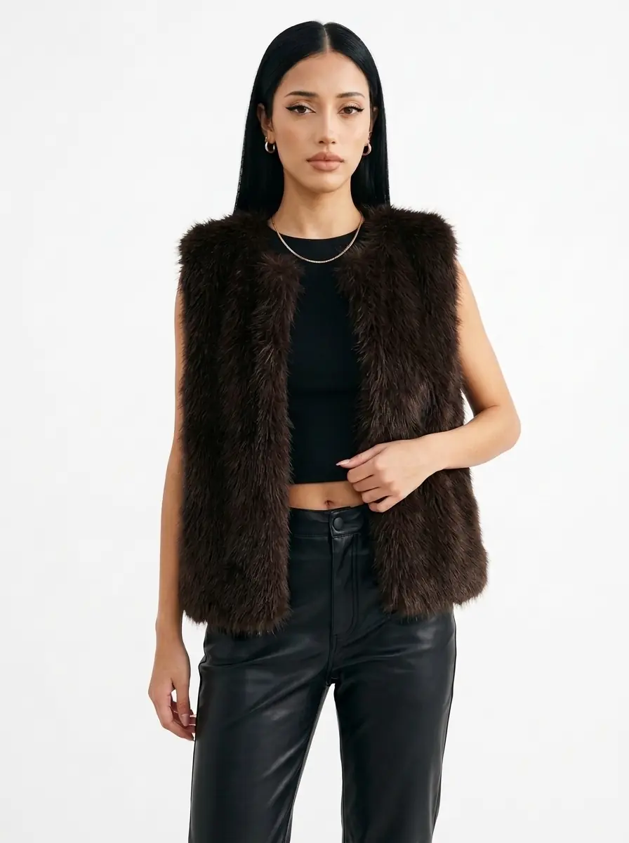 Woman modeling a dark brown faux fur vest with black pants