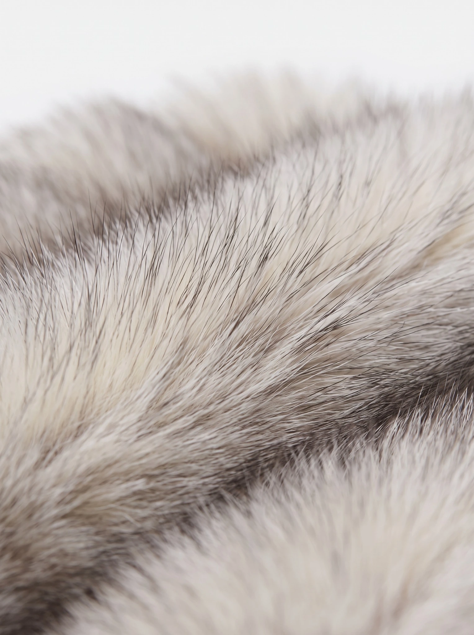 Close-up of gray faux fur with darker tips showing the jacket’s soft, layered texture