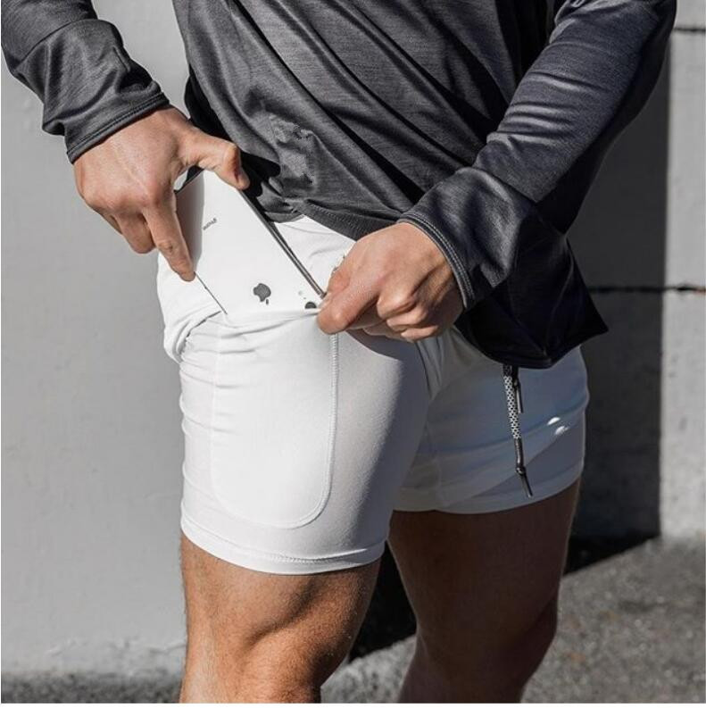 Short de sport respirant 2 en 1 pour homme, idéal pour la course et l'entraînement, avec poches pour téléphone. Disponible en 19 couleurs.