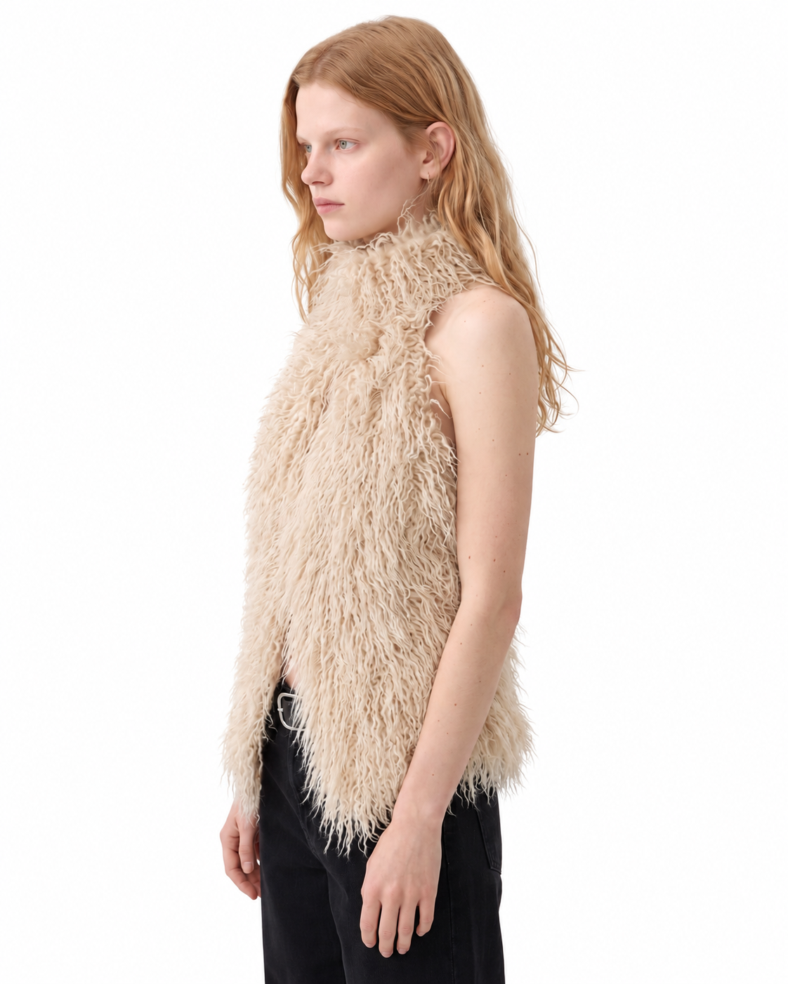 Three-quarter view of a woman wearing a beige shaggy faux fur halter top.