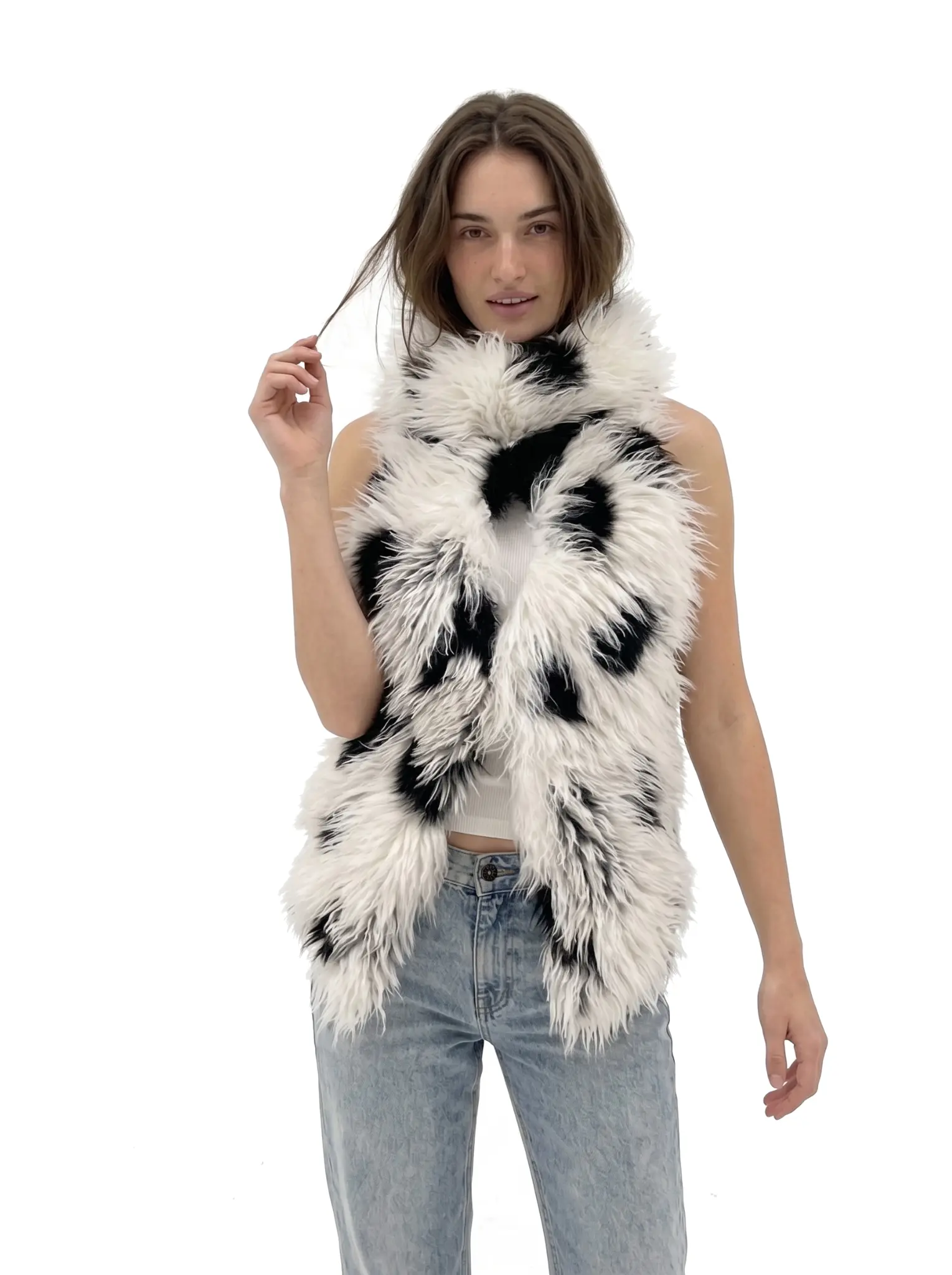 Profile view of a woman wearing a spotted faux fur halter vest