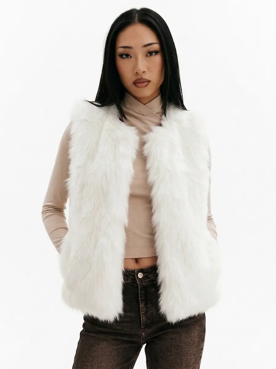 Front view of a woman wearing a white faux fur vest