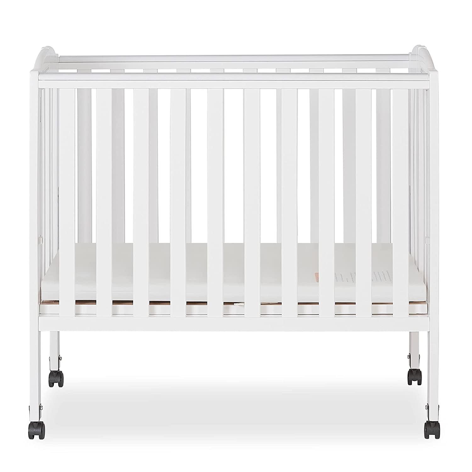 Dream on Me 2 - in - 1 Folding Portable Mini Crib in White. Mattress Pad Included. Easy to Fold and Store Baby Crib. Two Adjustable Mattress Height Positions Convertible Crib