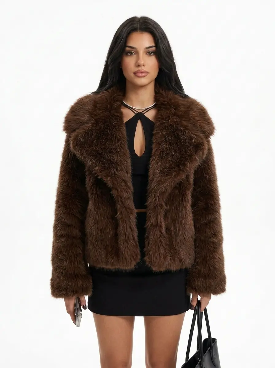 Woman modeling a brown faux fur jacket with a black mini dress