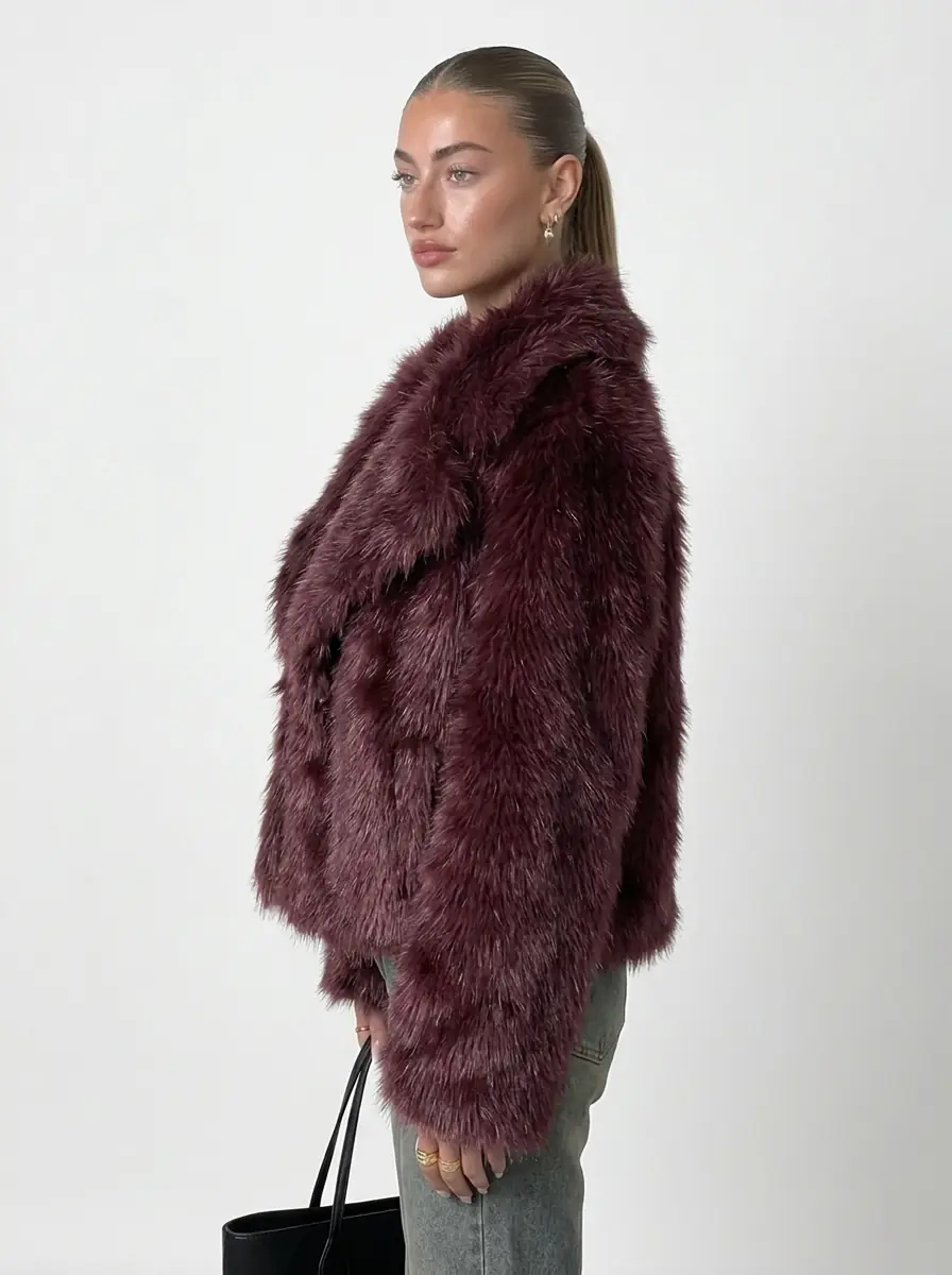 Side view of a woman wearing a maroon faux fur jacket