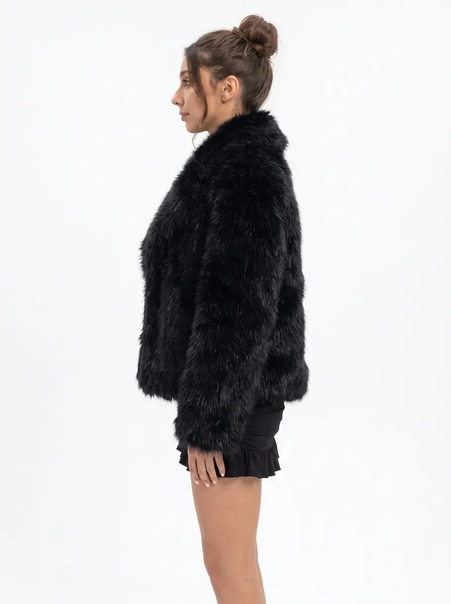 Side view of a women's black faux fur jacket