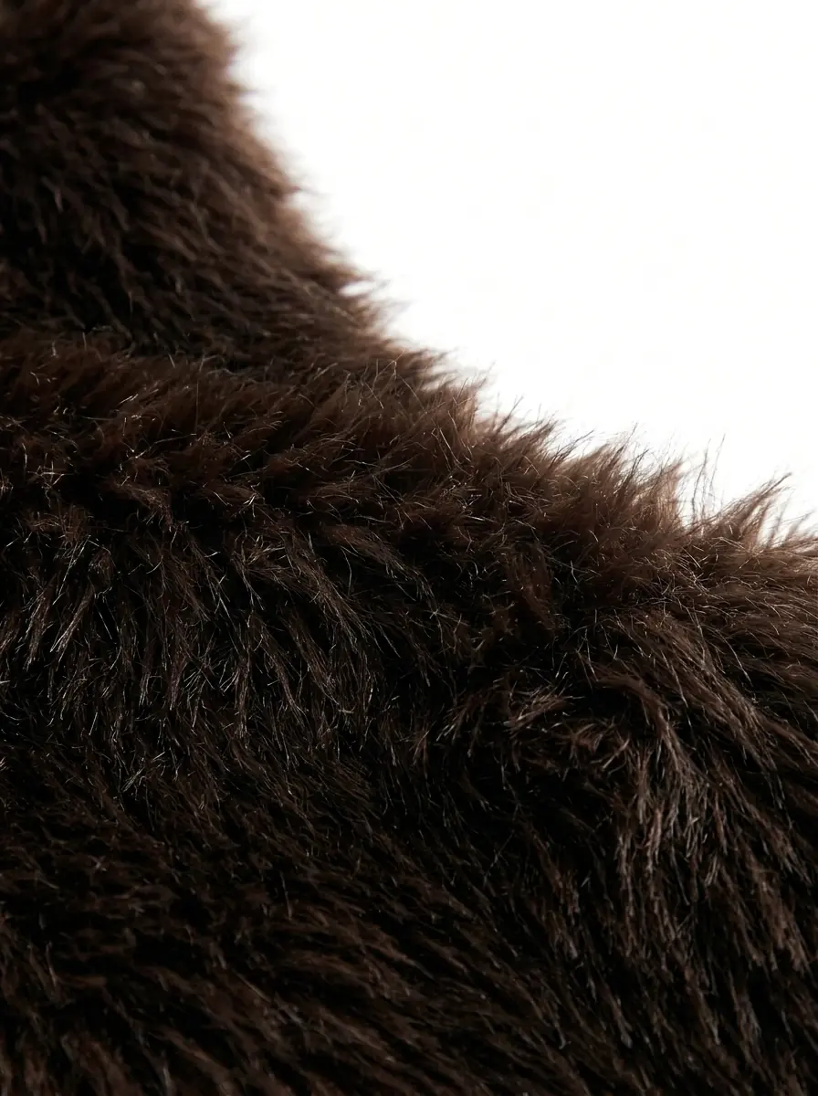 Close-up of soft dark brown faux fur vest texture