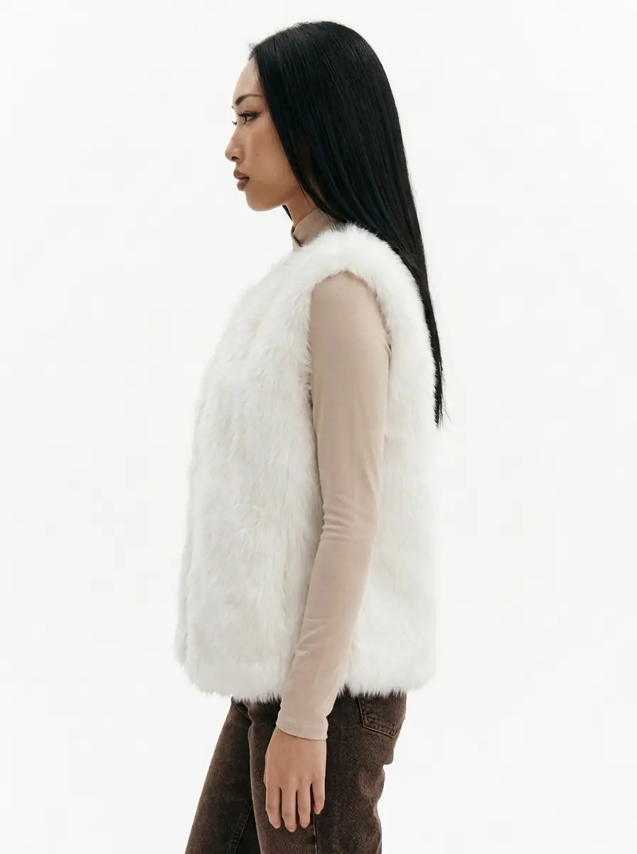 Side view of a woman wearing a white faux fur vest