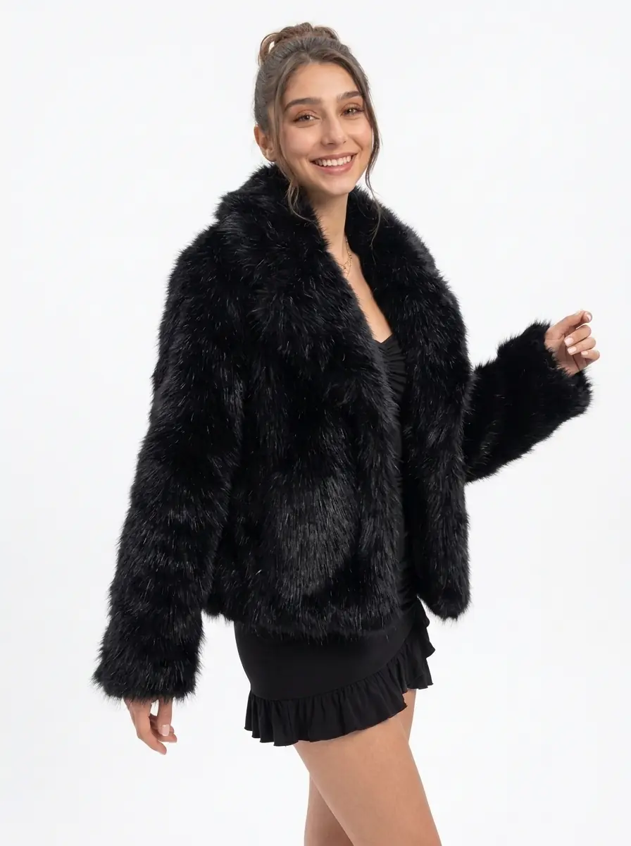 Woman wearing a black faux fur jacket in a three-quarter view