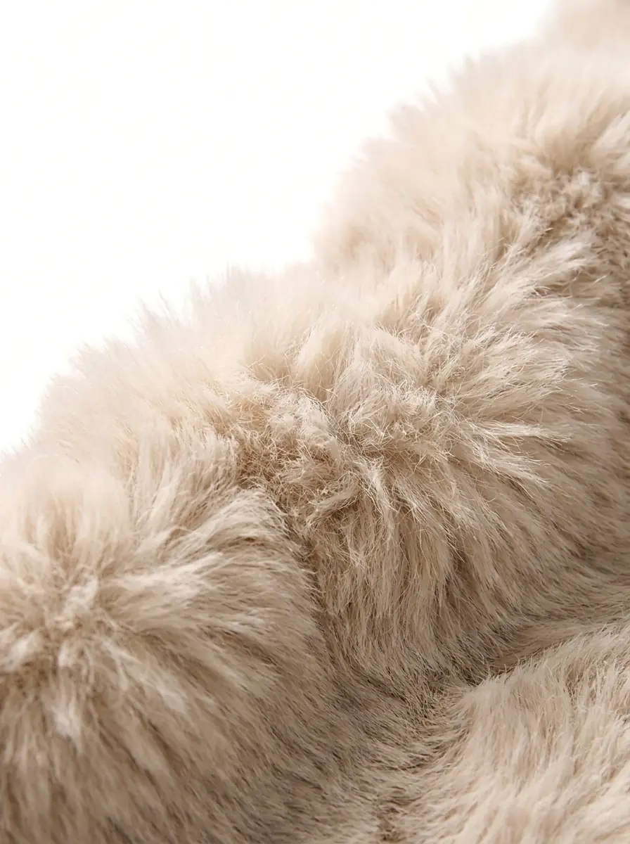 Close-up of soft beige faux fur jacket texture