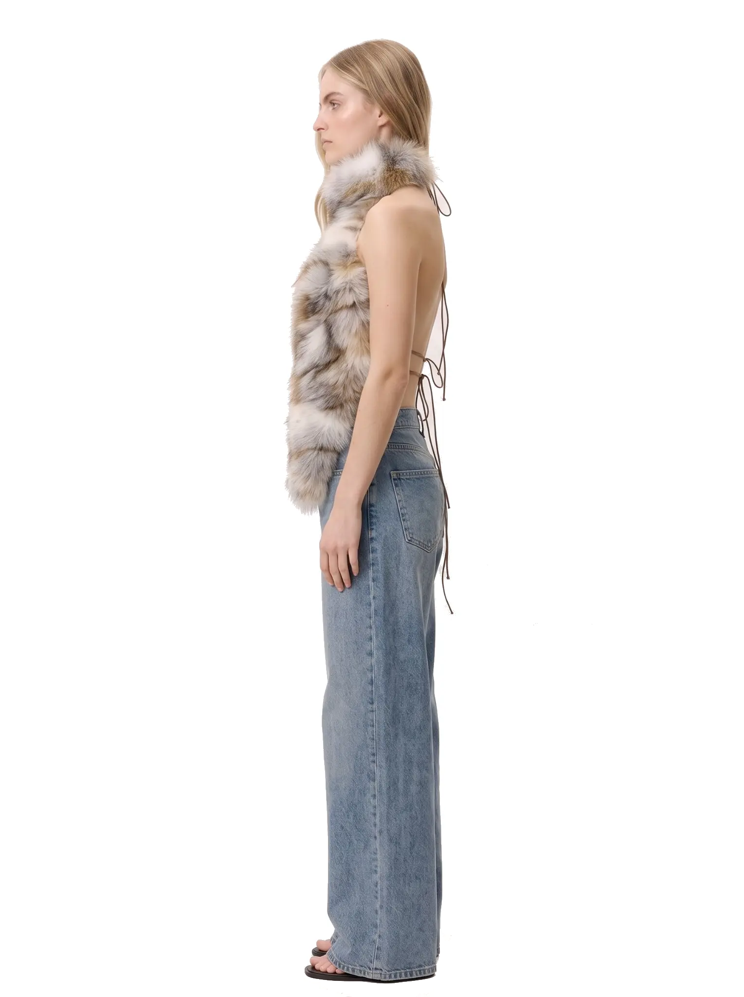 Left-side profile of a woman wearing a multicolor spotted faux fur halter vest