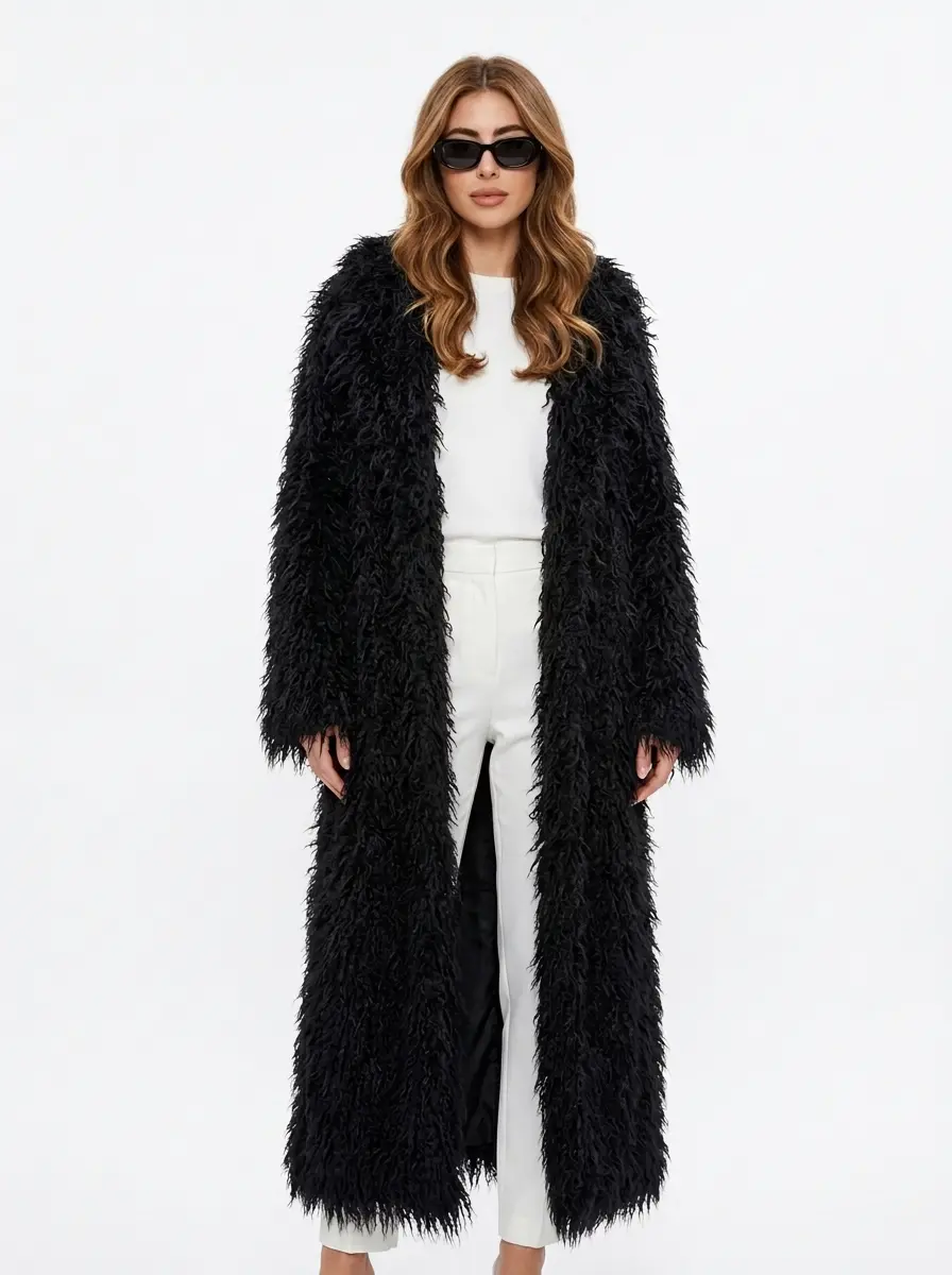 Model wearing a black long faux fur coat with full-length silhouette