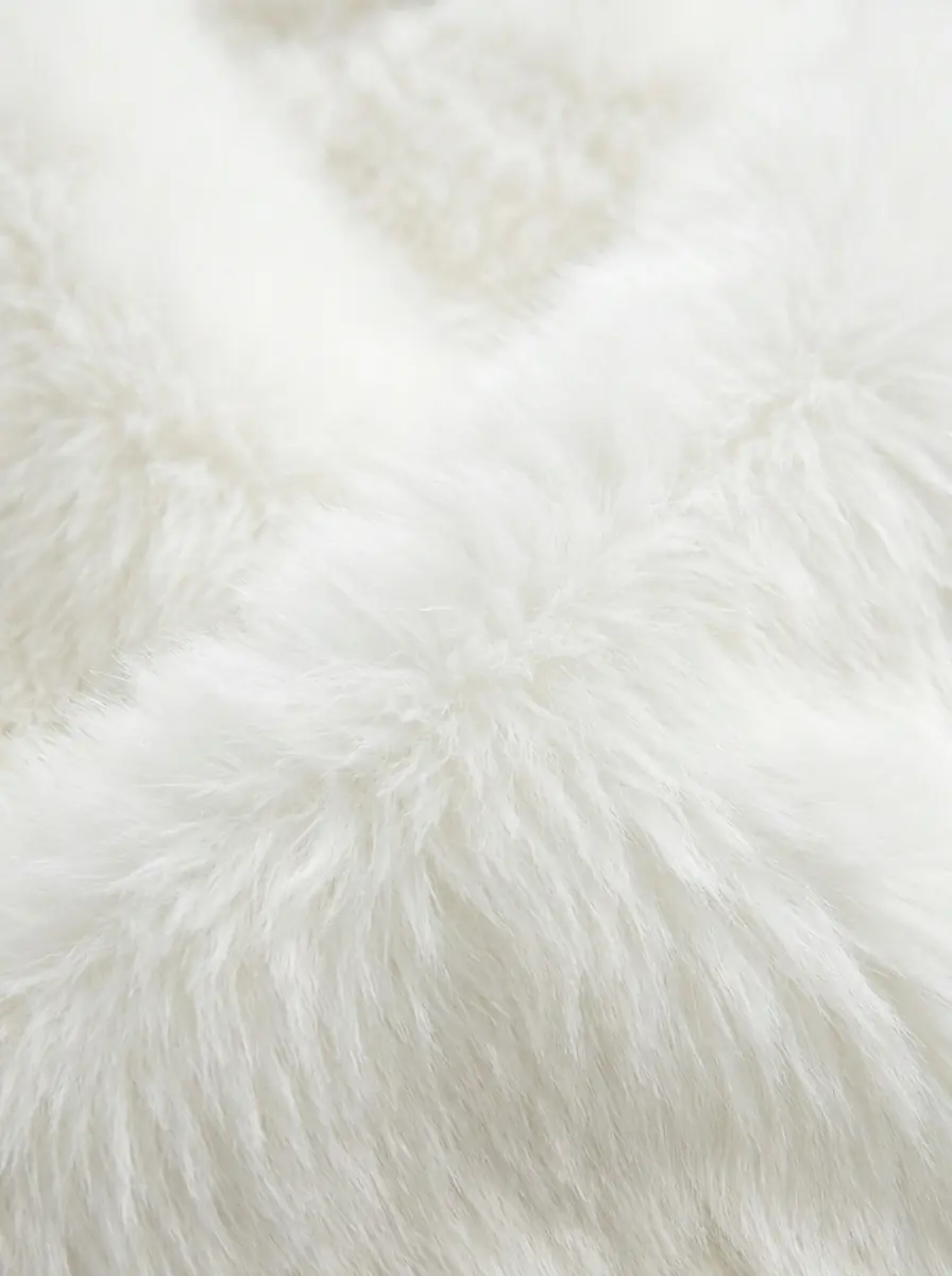 Close-up of soft white faux fur jacket texture