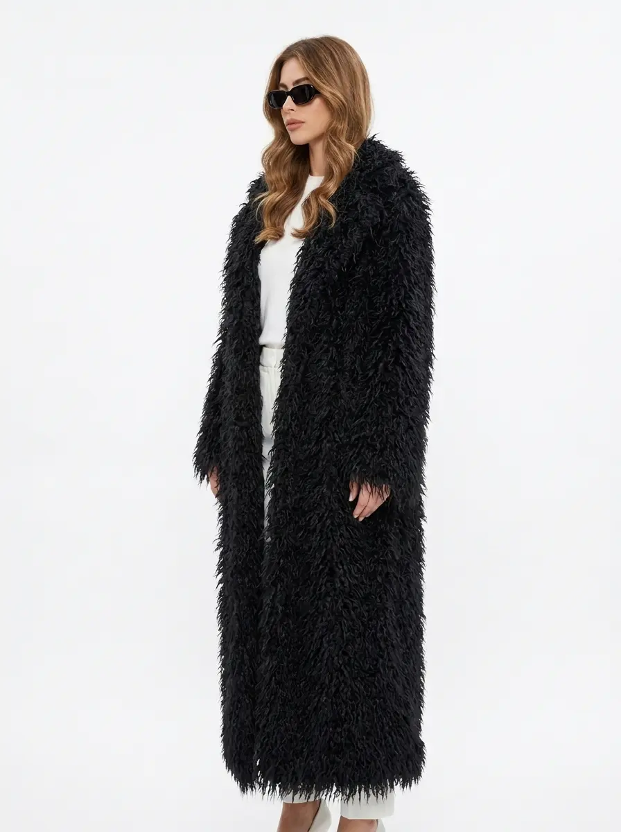Side view of a women’s black long faux fur coat