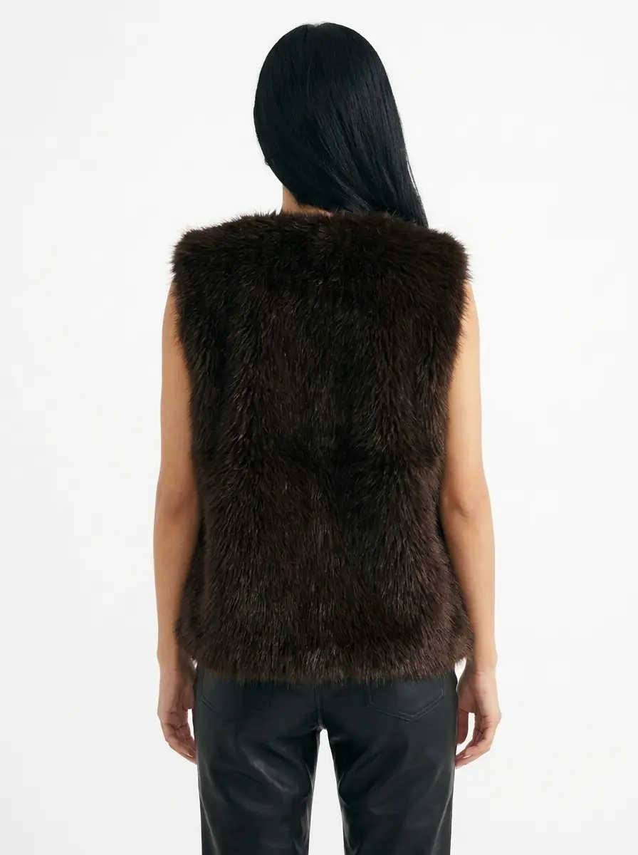 Back view of a women's dark brown faux fur vest