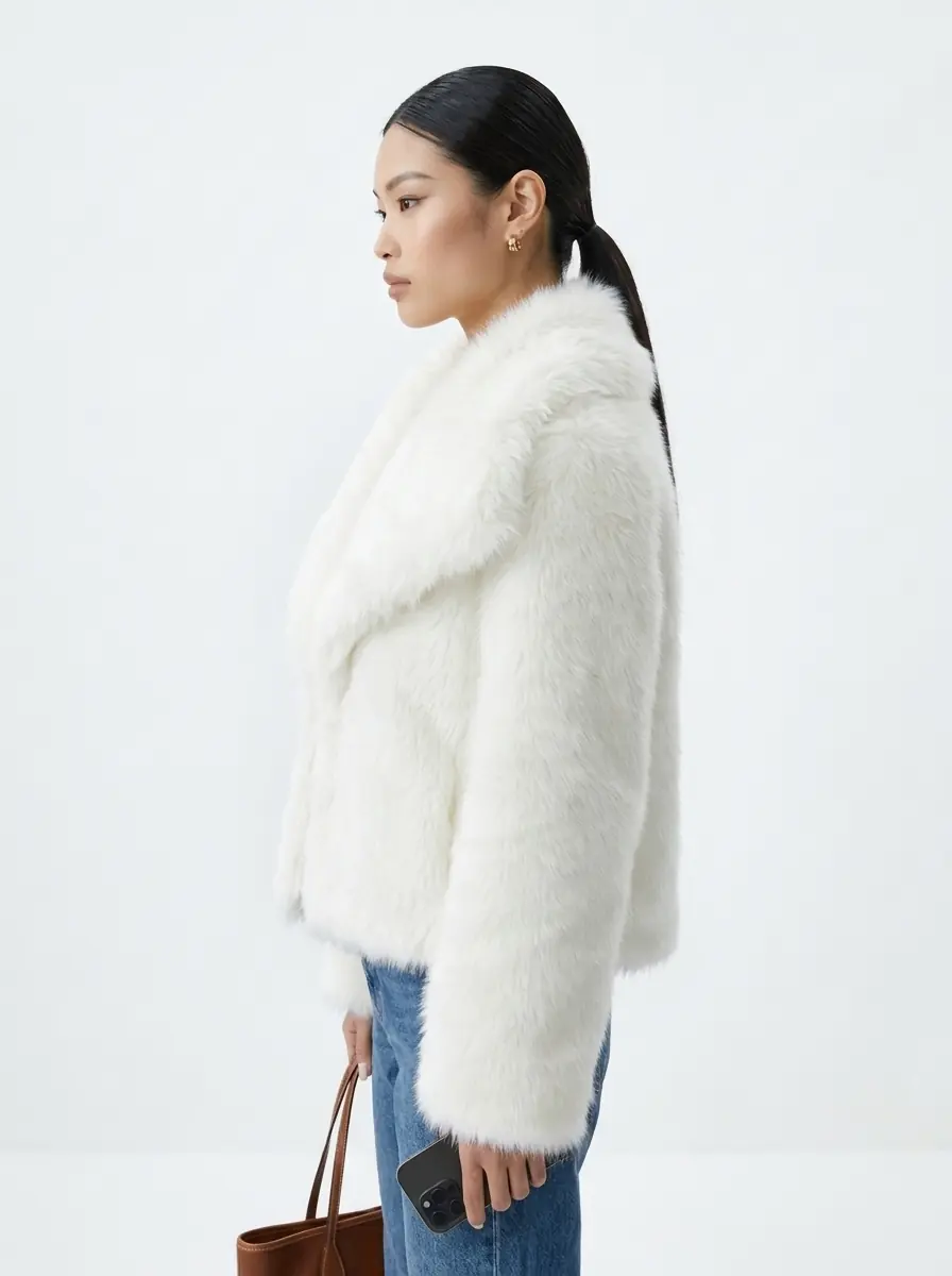 Side view of a woman wearing a white faux fur jacket