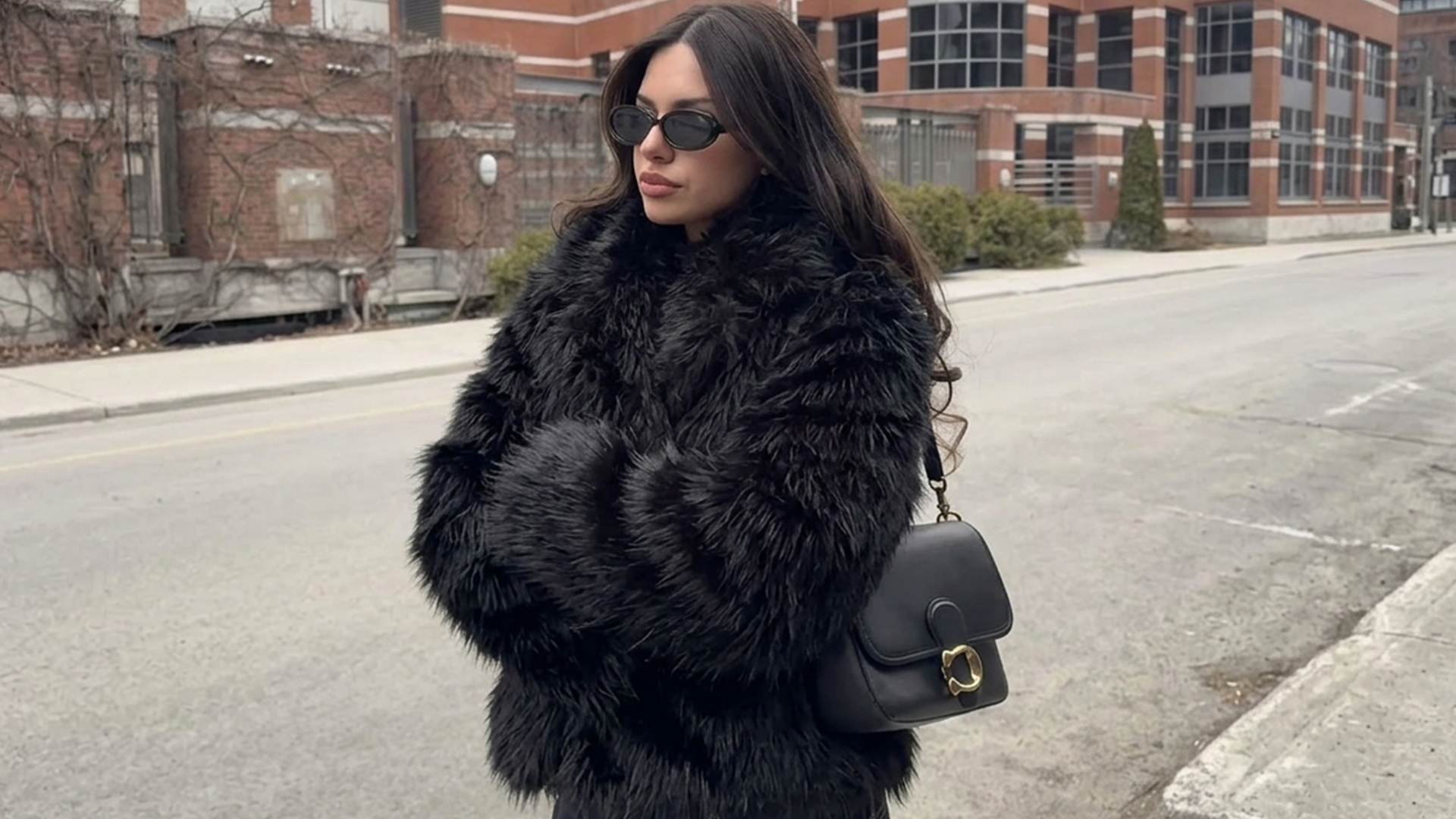 Woman wearing a pink faux fur coat indoors