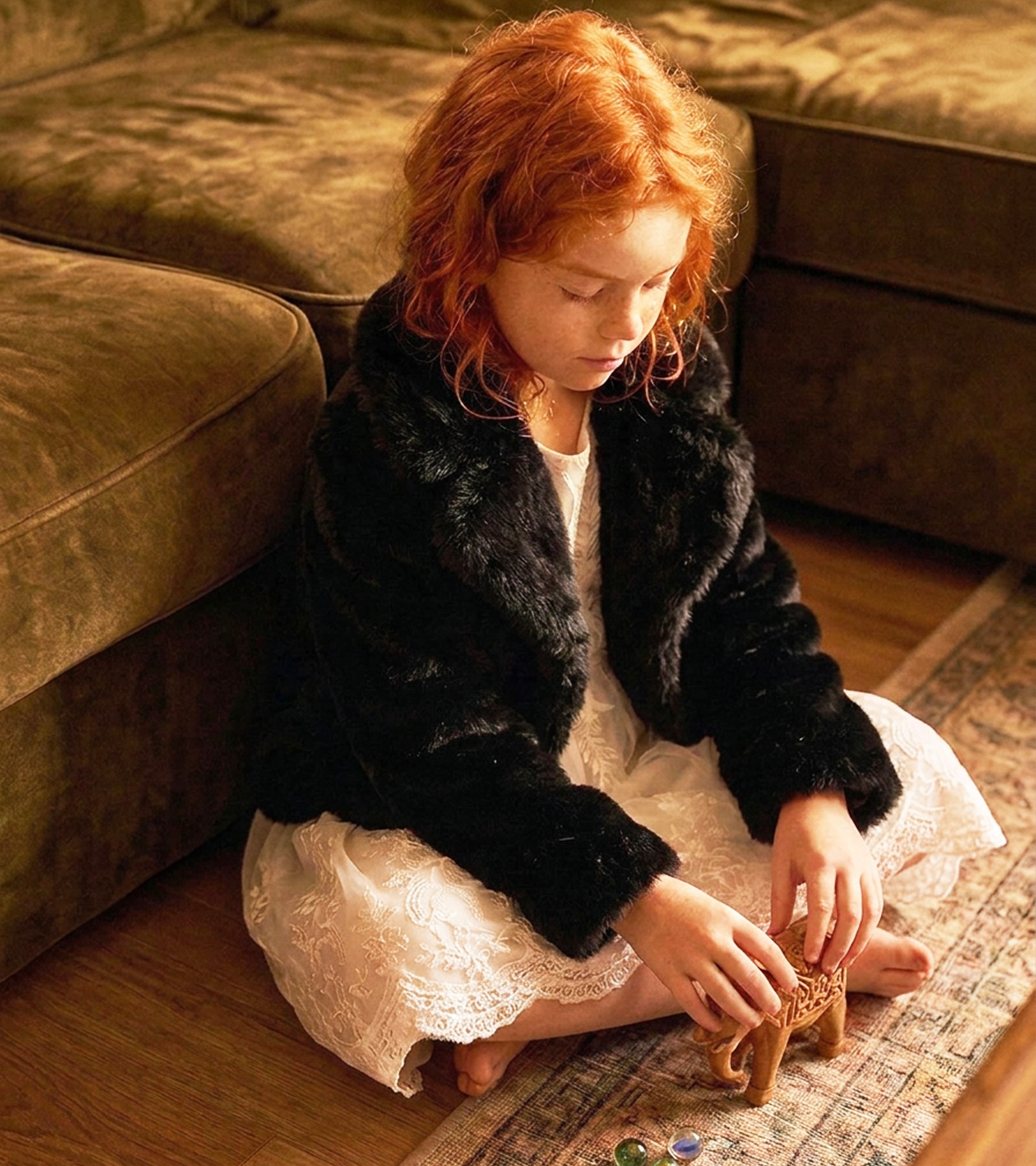 Girl wearing a black Stanetco faux fur jacket indoors