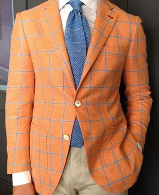 Blazer décontracté à carreaux orange, revers cranté et deux boutons.