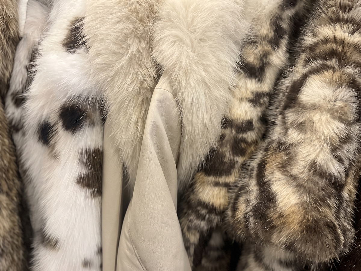 Faux fur coats hanging in a wardrobe for material care and storage
