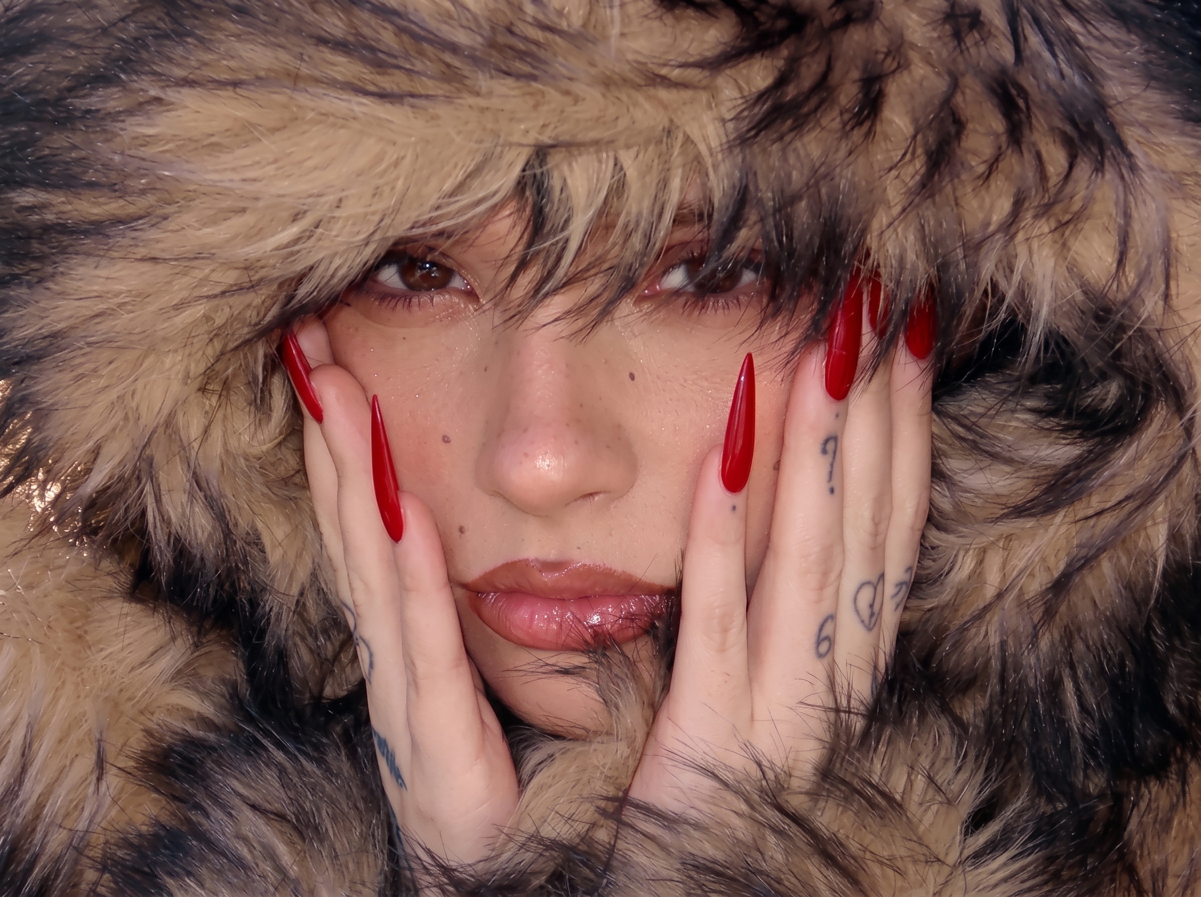Close-up of a woman wearing a brown and black faux fur hooded jacket