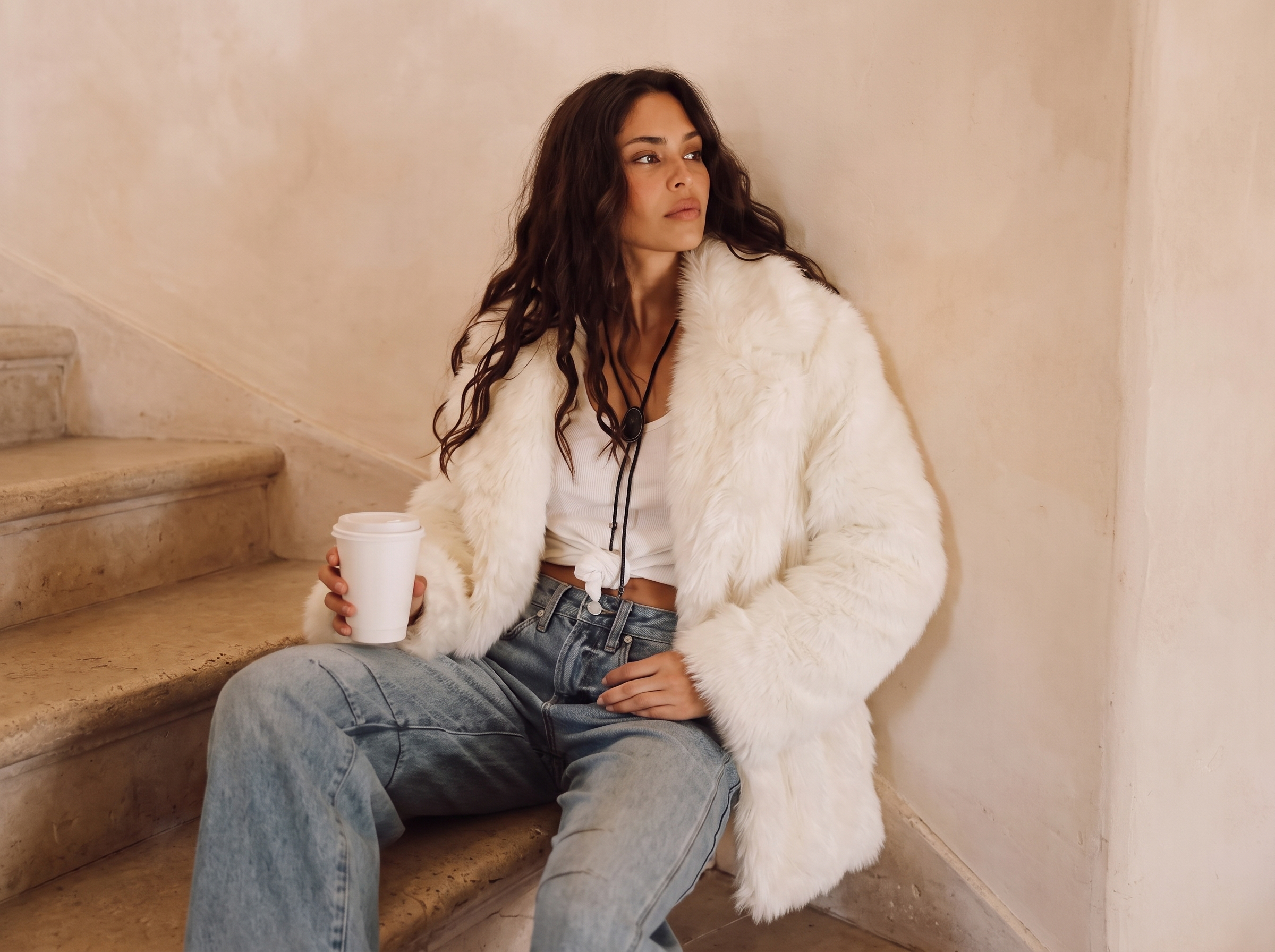 Woman wearing a plush faux fur jacket for a stylish winter outfit
