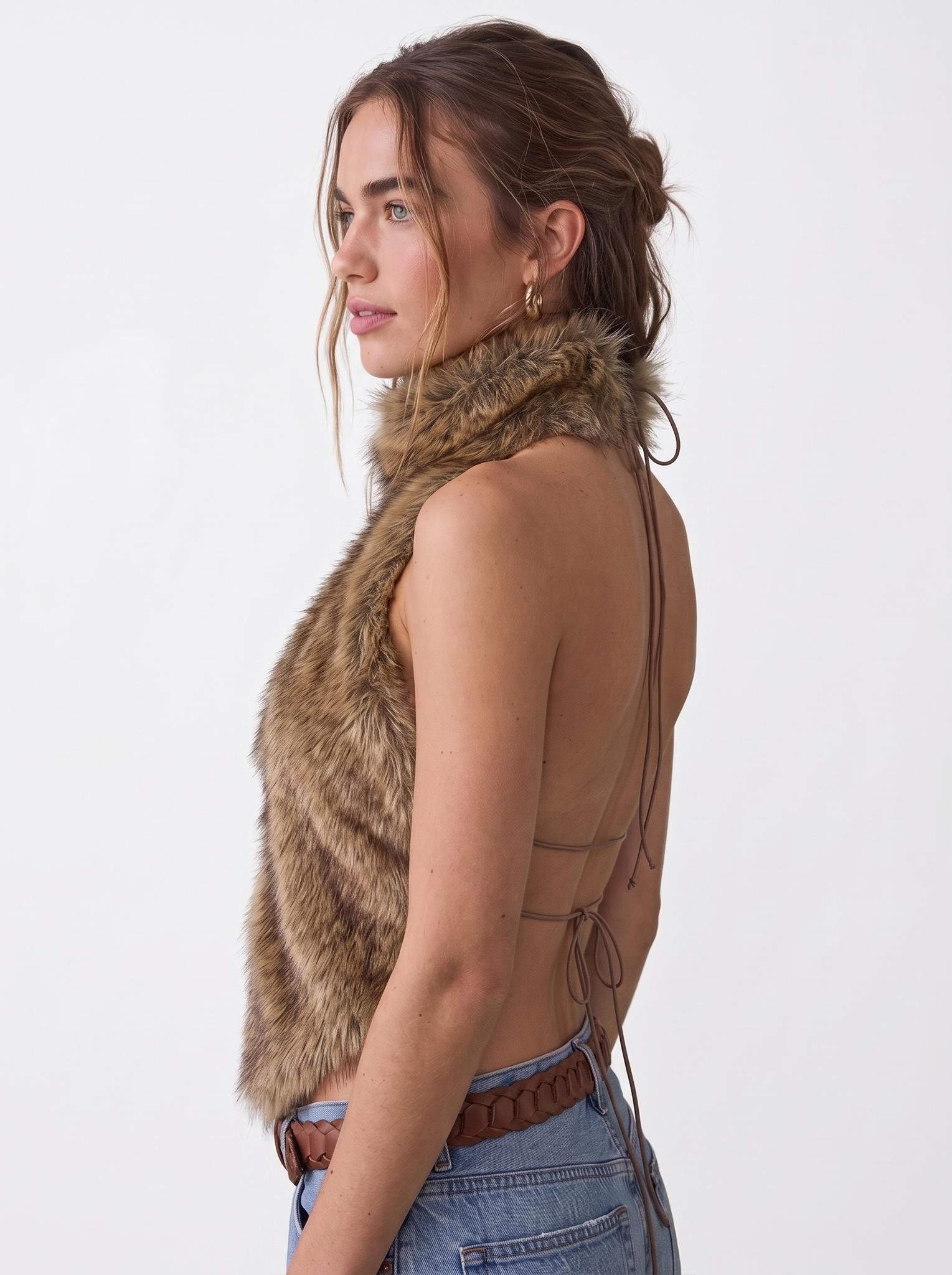 Side view of a woman wearing a brown faux fur halter vest