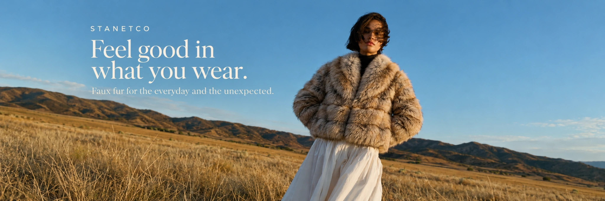 Stanetco model wearing a tan faux fur jacket in a golden field. Text reads: Feel good in what you wear. Faux fur for the everyday and the unexpected.