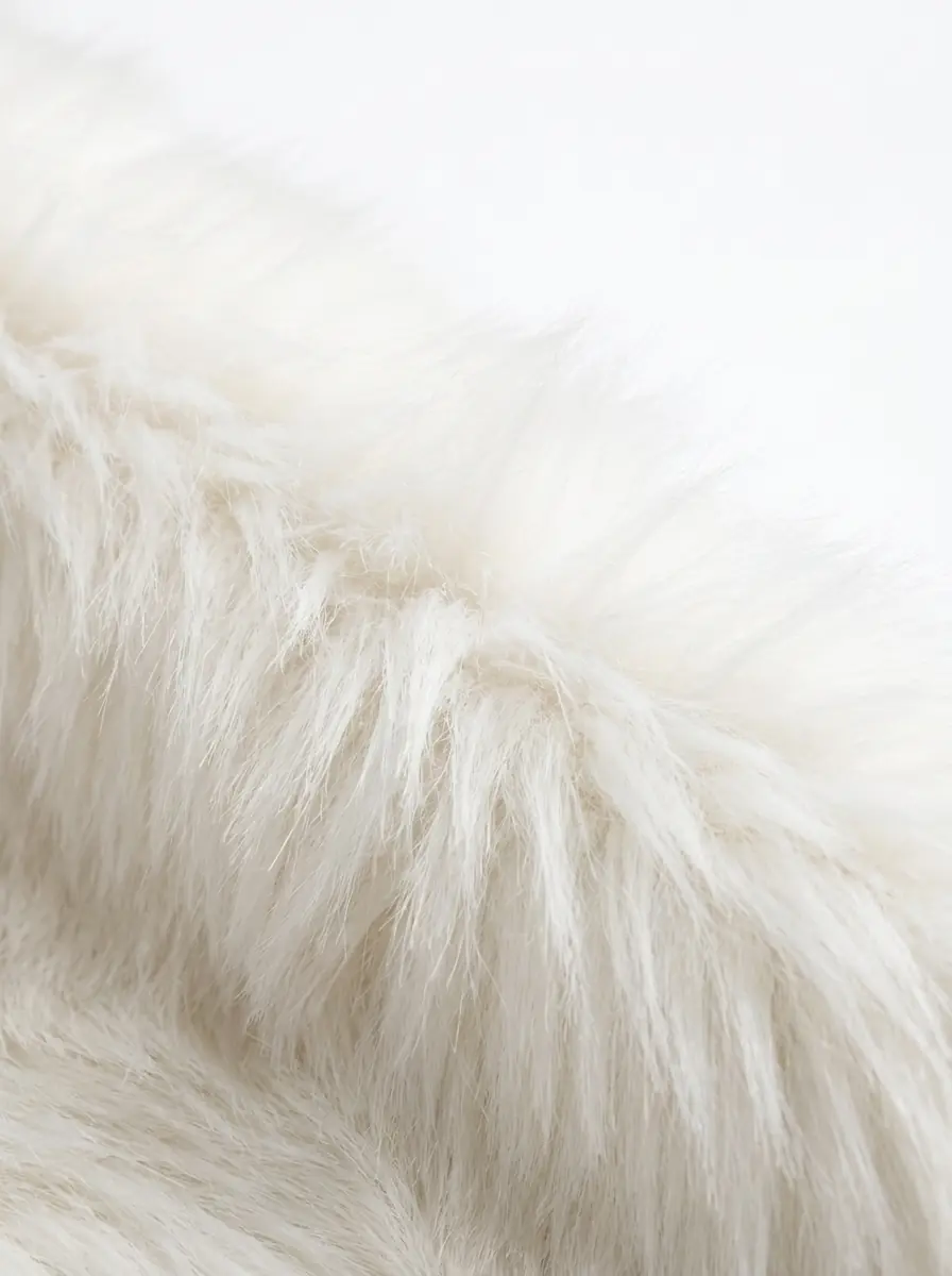 Close-up of soft white faux fur coat texture